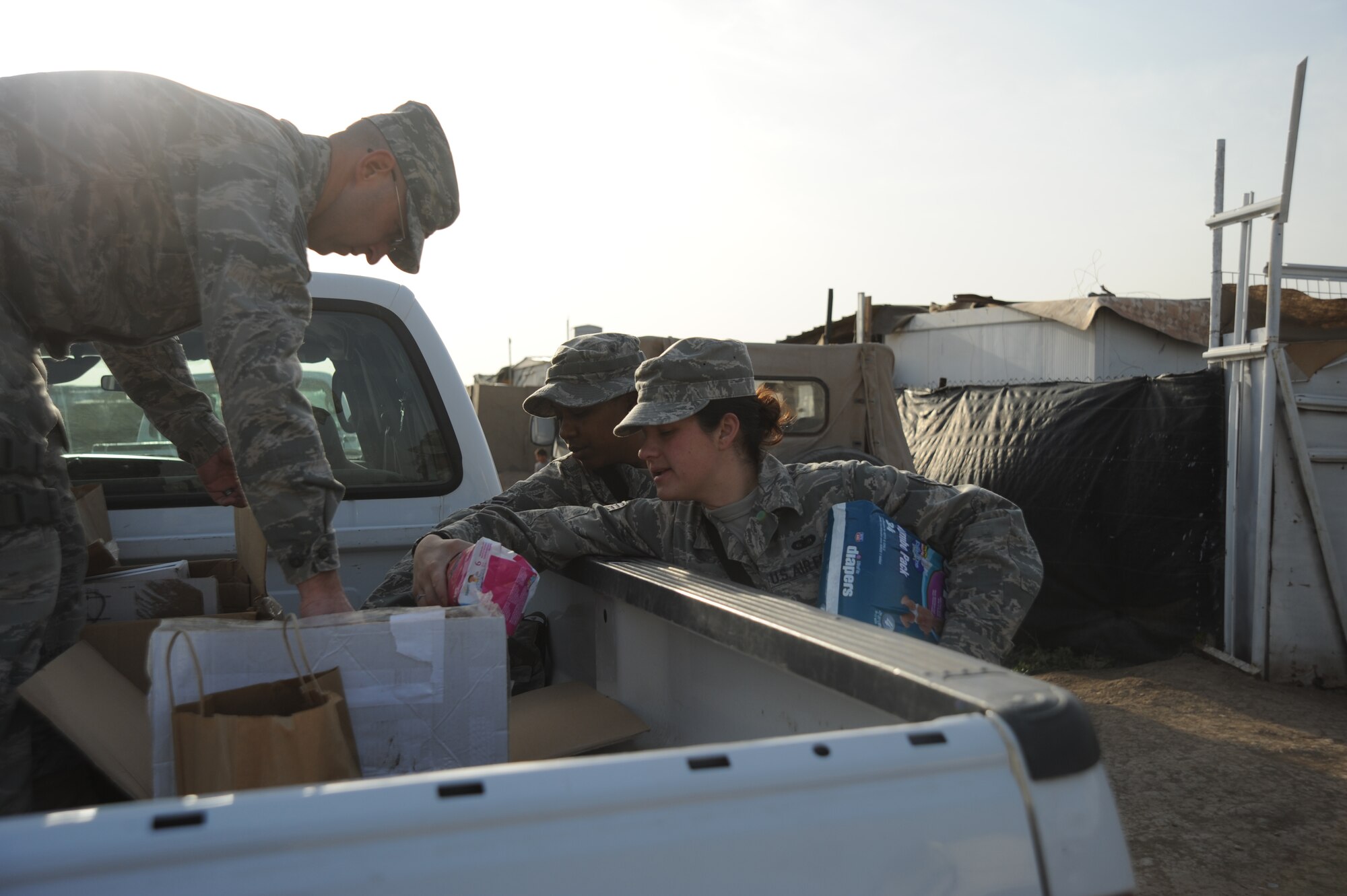 Airmen from Sather Air Base unload items to distribute to Iraqi families during the Good Neighbor Program Jan. 29, 2010. The GNP collects donated items such as toys, clothes, games, school supplies, and other needed items for distribution throughout the Iraqi community.  (U.S. Air Force photo/ Senior Airman Eric Summers Jr/ released)