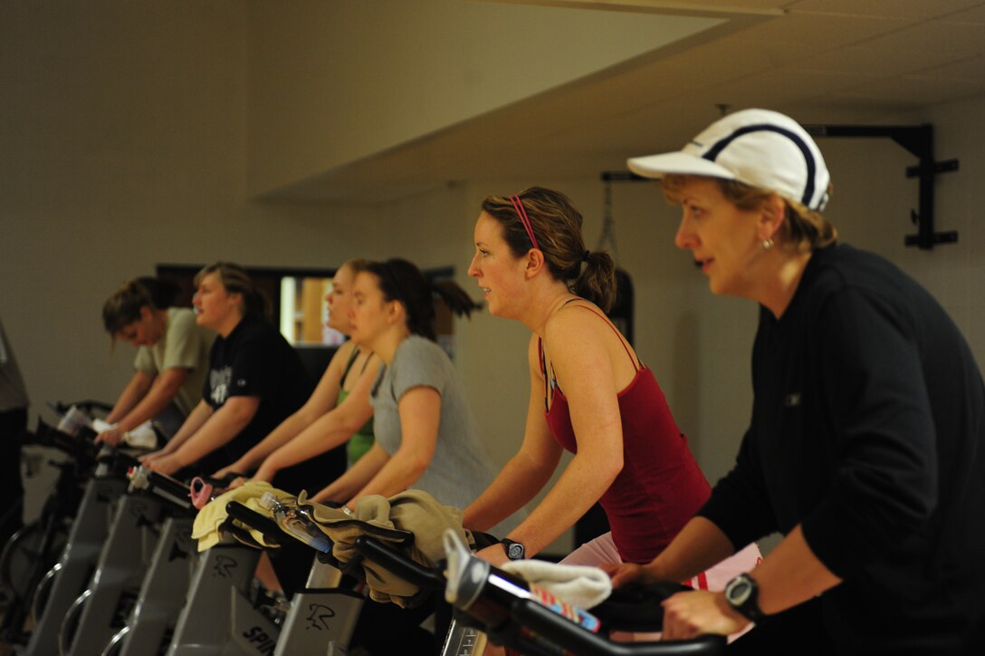 ELLSWORTH AIR FORCE BASE, S.D. -- Wives of deployed Airmen endure through a spin class at the Bellamy Fitness Center, Feb. 2.  The "Freedom Miles" program was developed by key spouse Lori Waddell, 28th Force Support Squadron, as a means to stay active and meet other spouses of deployed Airmen. (U.S. Air Force photo/Airman 1st Class Anthony Sanchelli)


