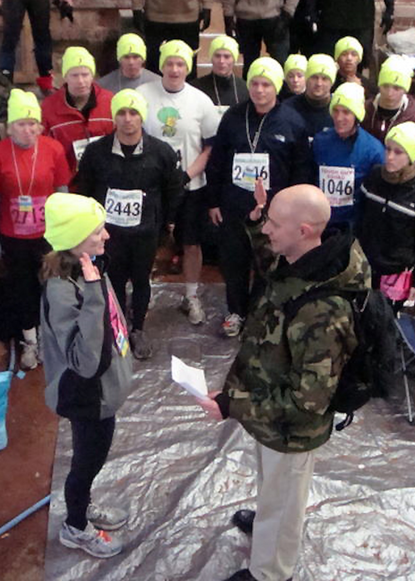 United States Navy Lt. Brent Helbig issues the reenlistment oath to Chief Petty Officer Michell Jordan just before she started the Tough Guy Challenge. (Photo by U.S. Army Staff Sgt. Carlos Lopez)