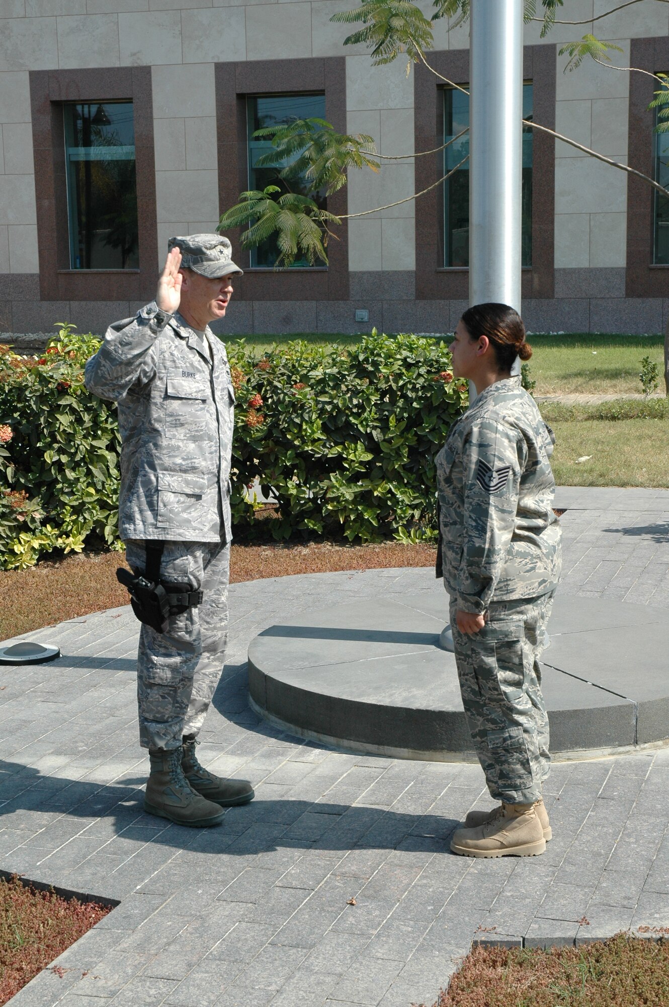 PORT AU PRINCE, Haiti -- Brig. Gen. Darryl Burke, the Air Component Coordination Element director at Joint Task Force-Haiti and Air Forces Southern vice commander, administers the oath of enlistment to Tech. Sgt. Diane Brown, during an impromptu promotion ceremony.  The ceremony was attended by members of the JTF-Haiti Joint Operations Center and the Joint Personnel Recovery Center where Sergeant Brown works in support of Operation Unified Response.  (U.S. Navy photo by Lt. Cmdr. C. Straw)