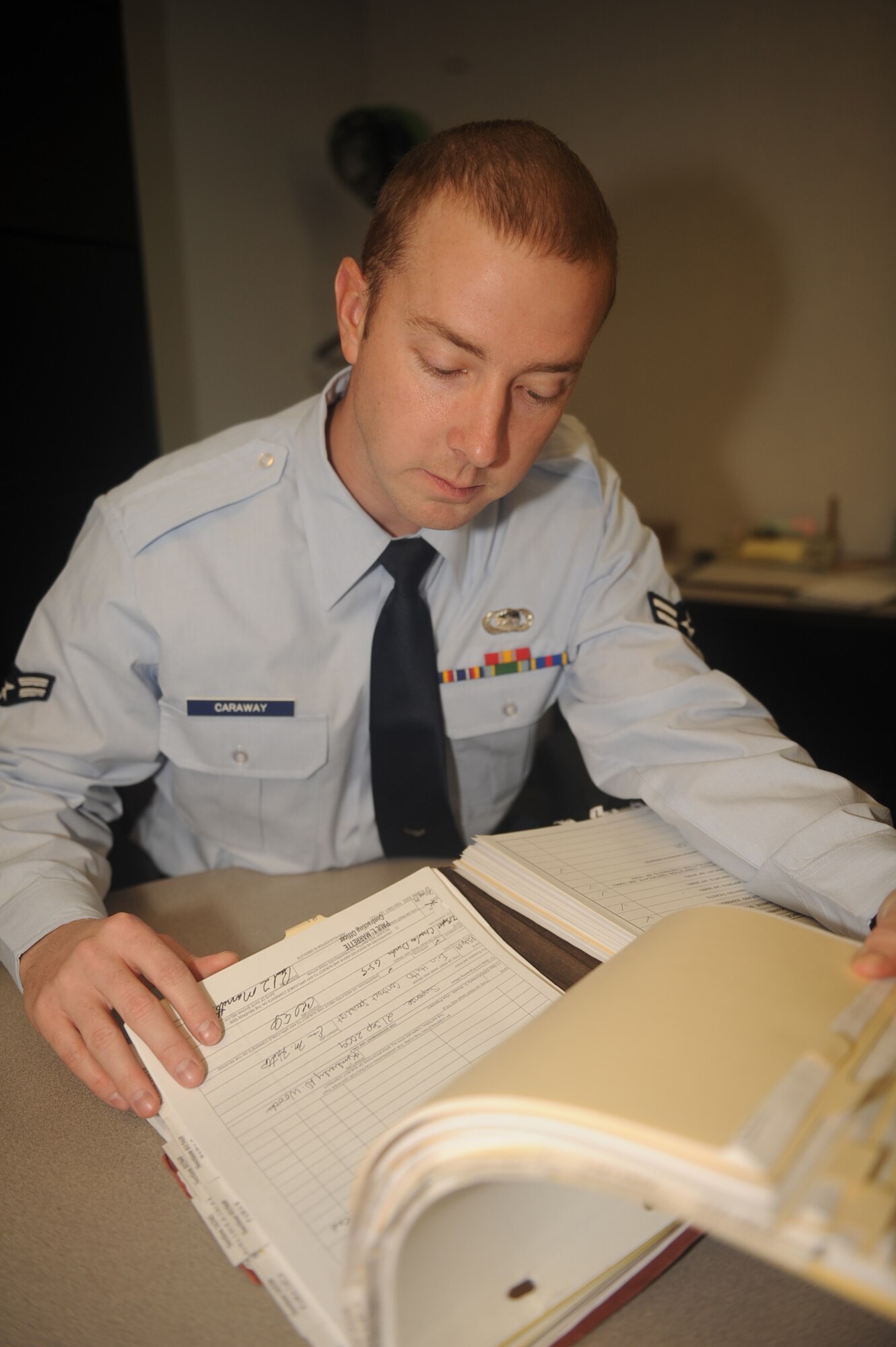 Airman 1st Class Aaron Caraway, 4th Contracting Squadron contracting specialist, reviews a contract for discrepancies on Seymour Johnson Air Force Base, N.C., Jan 4, 2010. Reviews ensure the government and contractors are upholding their legal obligations under the contract. Airman Caraway hails from Minden, La. (U.S. Air Force photo/Senior Airman Ciara Wymbs)