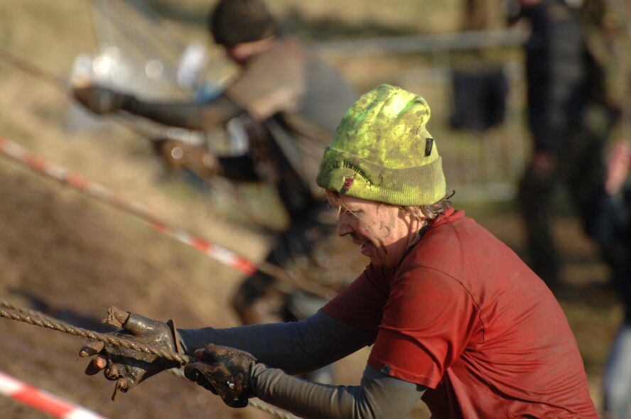 Master Sgt. Teresa Stiner climbs a steep mud hill during the Tough Guy Challenge near Birmingham, England.    (Photo by Air Force Staff Sgt. Javier Cruz)