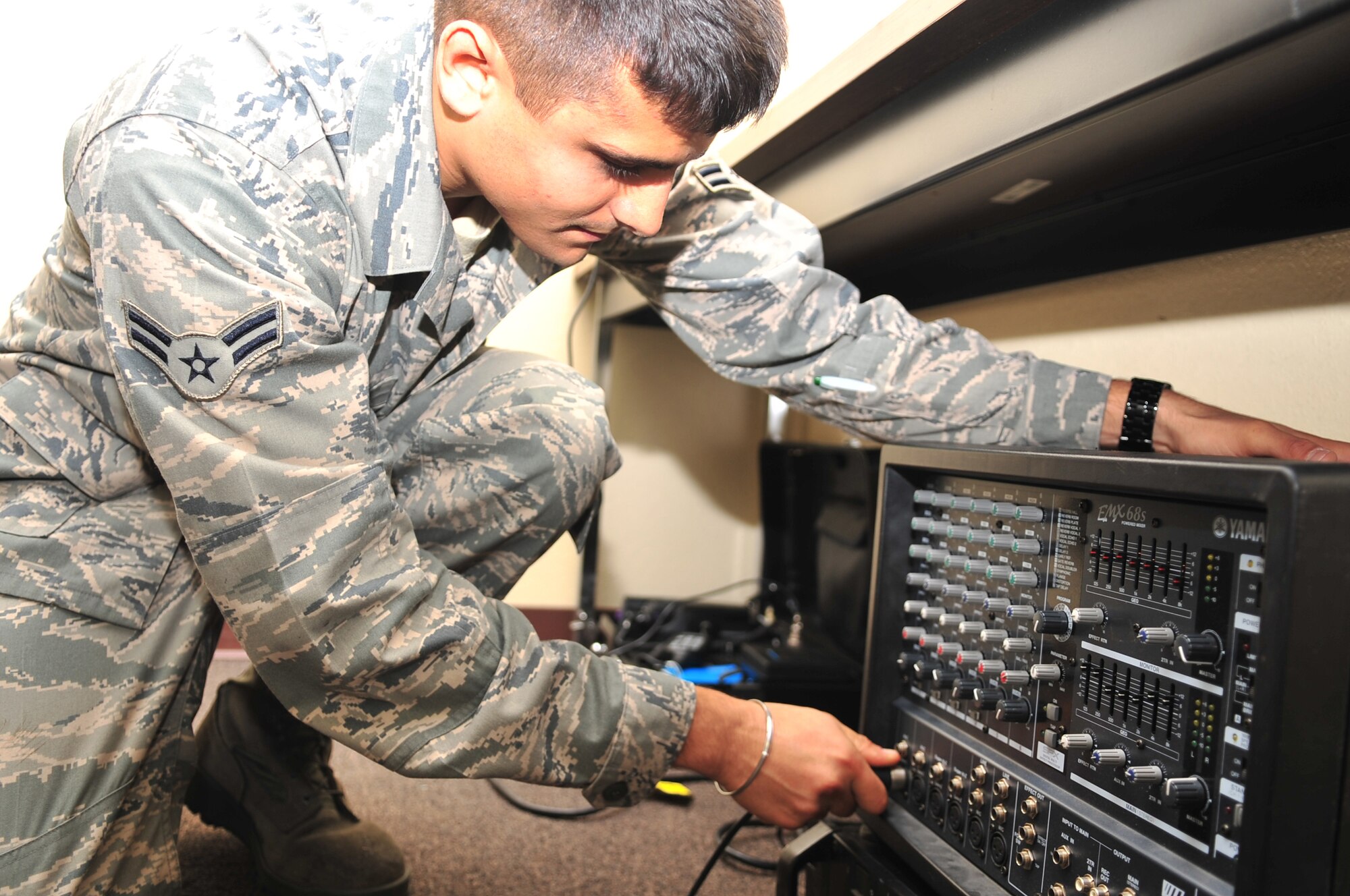 Airman 1st Class Ross O'Donnell, 4th Communications Squadron transmission systems technician, inserts a leads cable into an amplifier for the giant voice system on Seymour Johnson Air Force Base, N.C., Dec. 3, 2009. The amplifier relays messages to Airmen in Base X during a Phase II operational readiness exercise.  Airman O'Donnell is a native of Fishers, Ind. (U.S. Air Force photo/Airman 1st Class Rae Perry)