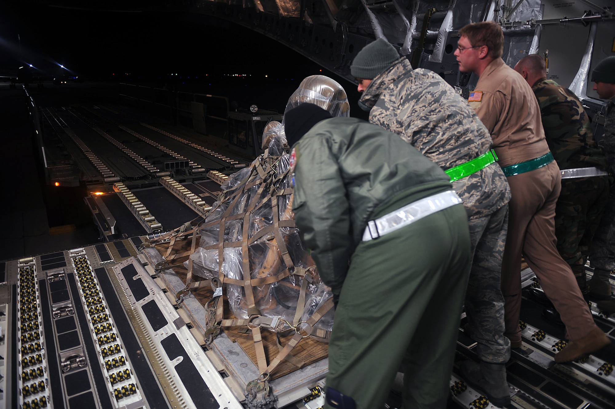 Airmen from the 4th Logistics Readiness Squadron unload a pallet from a C-5 Galaxy at Seymour Johnson Air Force Base, N.C., Jan. 8, 2010. The pallet contained equipment used by Airmen from the 335th Fighter Squadron and 335th Aircraft Maintenance Unit while deployed in support of Operation Enduring Freedom. (U.S. Air Force photo/Senior Airman Ciara Wymbs)