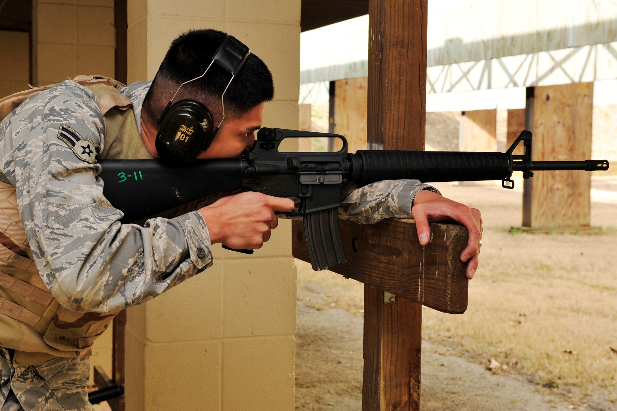 Airman 1st Class Enrique Pecson, 19th Civil Engineer Squadron engineering apprentice, fires over barricade with an M-16A2 rifle as part of his qualification Jan. 21. The over barricade position is the last string in the firing sequence. (U.S. Air Force photo by Airman 1st Class Lausanne Pacheco)