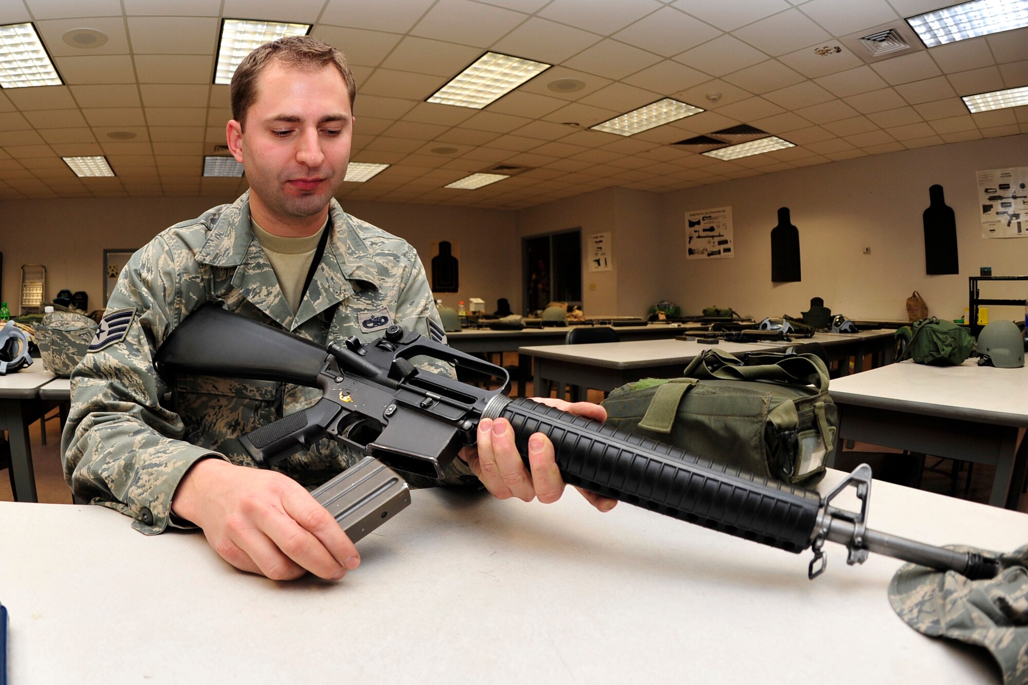 Staff Sgt. Robert Soger, 19th Equipment Maintenance Squadron corrosion control shift lead, practices placing and replacing a magazine into an M-16A2 rifle during a Combat Arms Training and Maintenance class Jan 21. The proper way to load a weapon is to release the bolt catch/release and then insert magazine. (U.S. Air Force photo by Airman 1st Class Lausanne Pacheco)