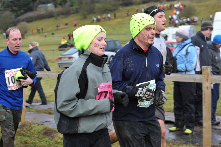 United States Navy Chief Petty Officers, Michell Jordan and Jesse Harrahill share words of encouragement during the Tough Guy Challenge near Birmingham, England.   (Photo by Air Force Staff Sgt. Javier Cruz)