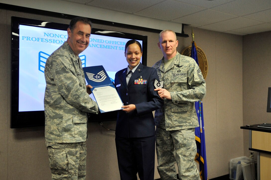 Major Gen. Gar Graham, 79th Medical Wing commander, and Command Chief Master Sgt. Roddy Hartsook, 79 MDW command chief, present step promoted Tech. Sgt. Chatoya Garner, 779th Medical Support Squadron systems personnel, her technical sergeant stripes upon completion of the Non-comissioned officer Professional Enhancement Seminar (NCOPE) on Jan. 21, 2010. (U.S. Air Force photo by Staff Sgt. Renae L. Kleckner)(released) 