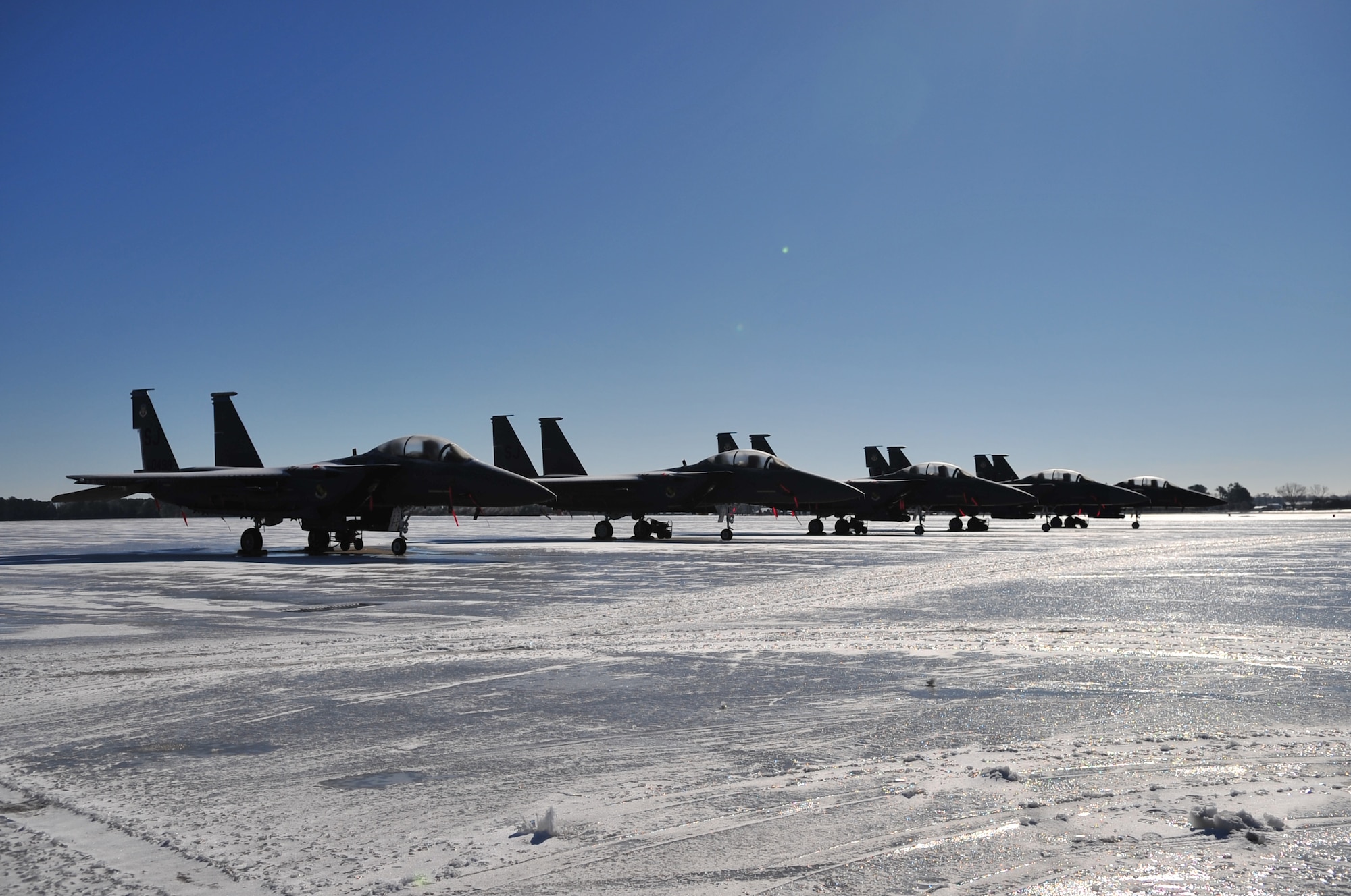 Five F-15E Strike Eagles sit on the frozen transient alert ramp at Seymour Johnson Air Force Base, N.C., Jan. 31, 2010. Snow plows and salt trucks were not used because Airfield Management and the 4th Civil Engineer Squadron commander chose to see if the snow and ice would melt on its own. (U.S. Air Force photo/Senior Airman Rae Perry)