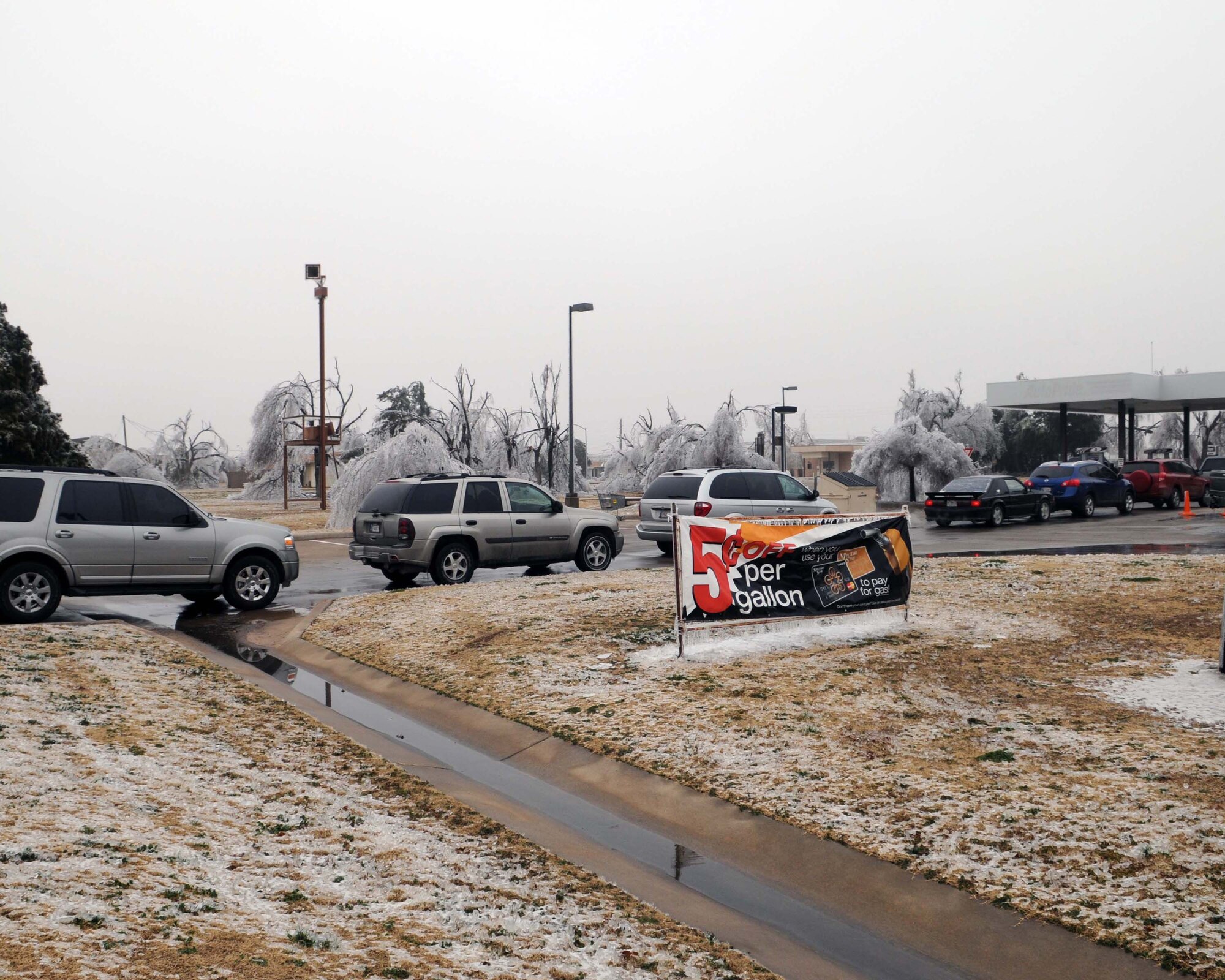 ALTUS AIR FORCE BASE, Okla. -- Base personnel wait in line at the AAFES Shoppette gas station to refuel their vehicles Feb. 1. Altus AFB received a generator from Vance AFB, Okla., which allowed the Shoppette to open Jan. 30. Many of the gas stations in the city of Altus, including the base, lost power due to an ice storm that hit Jan. 28. (U.S. Air Force photo/Senior Airman Leandra D. Hernandez)