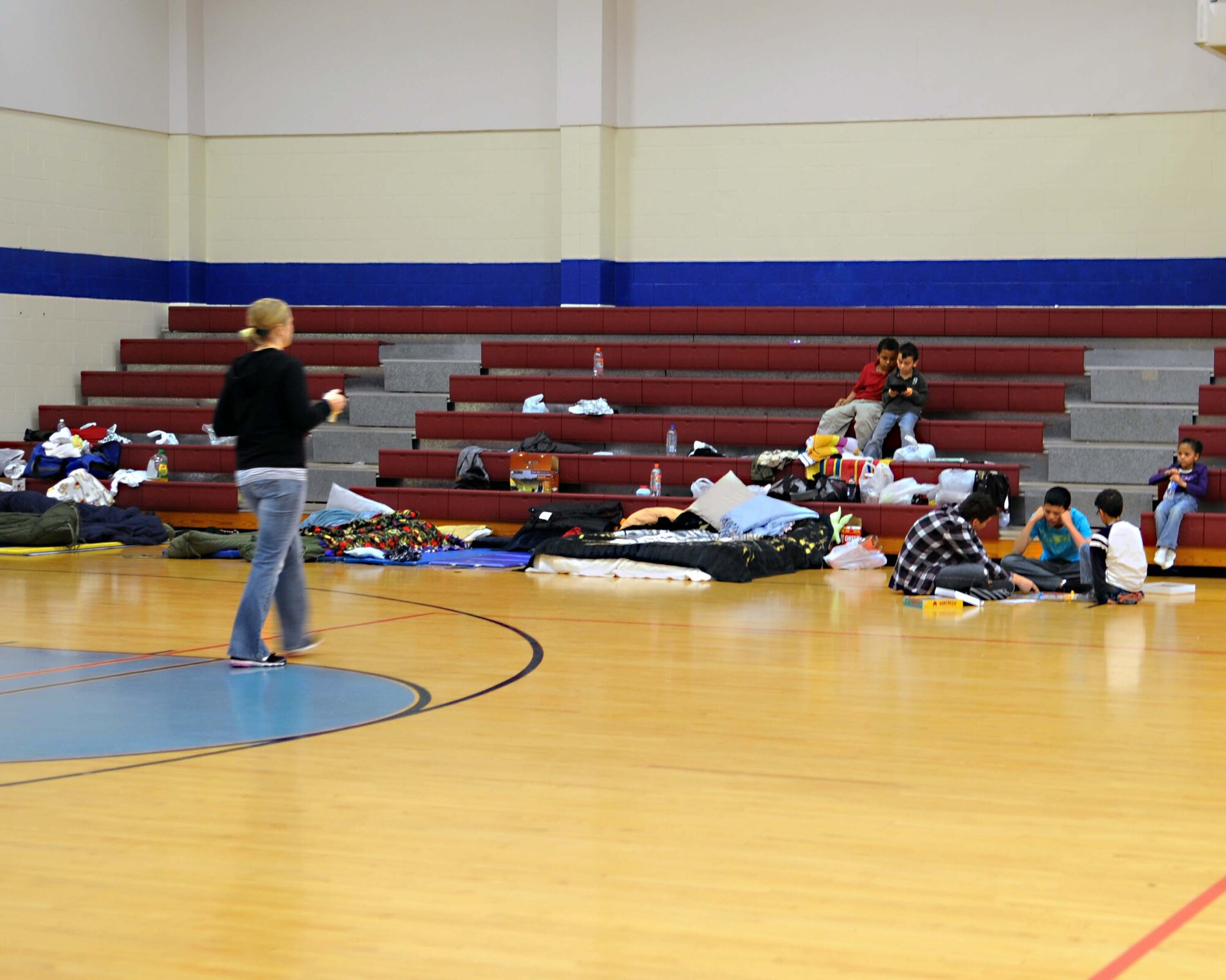 ALTUS AIR FORCE BASE, Okla. -- Altus AFB families take shelter at the Fitness Center Feb. 1. More than 200 Airmen and their families have taken shelter at the Fitness Center and the Medical Clinic during the power outage, which was cause by an ice storm Jan. 28. (U.S. Air Force photo/Senior Airman Leandra D. Hernandez)