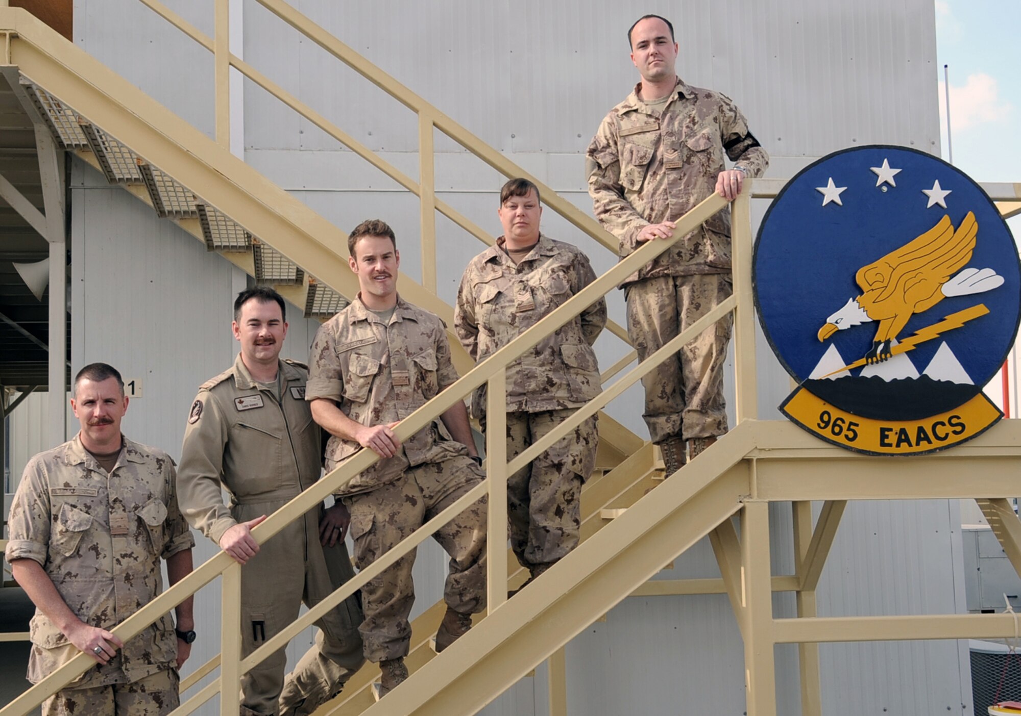 (From left) Maj. Scott Marshall, Capt. Chris Horner, Lt. Will Natynczyk, Sgt. Theresa McLaren, and Master Cpl. Mark Keown, all Canadian Forces members deployed with the 965th Expeditionary Airborne Air Control Squadron, stand at their squadron headquarters at a non-disclosed base in Southwest Asia on Jan. 28, 2010.  The five Canadian Airmen are a part of a crew on an E-3 Sentry Airborne Warning and Control System aircraft deployed from Tinker Air Force Base, Okla. The are a part of the 965th EAACS as part of North American Aerospace Defense Command agreement between the United States and Canada.  (U.S. Air Force Photo/Master Sgt. Scott T. Sturkol/Released)