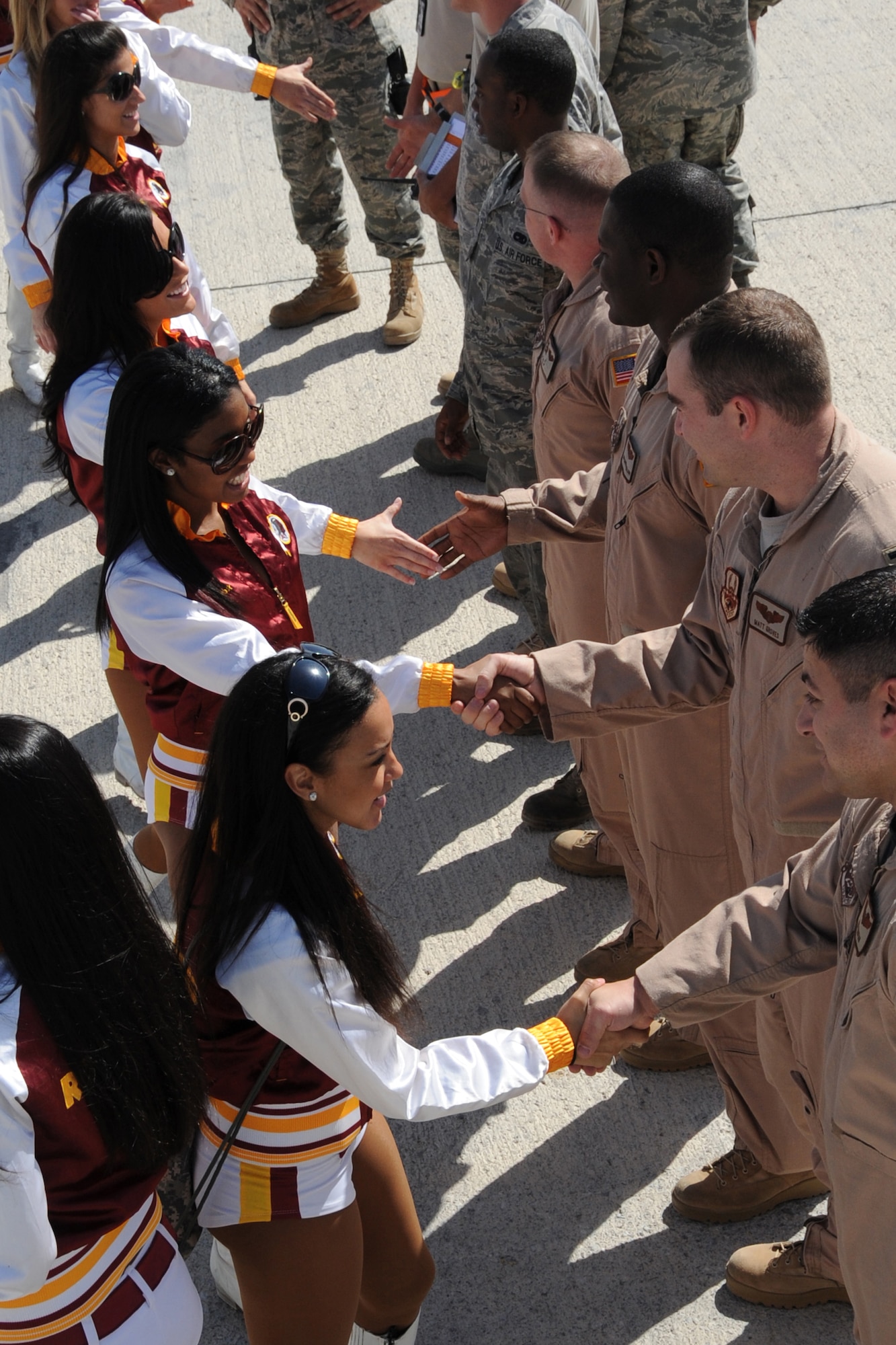 Members of the Washington Redskins cheerleading team greet Airmen of the 308th Air Expenditionary Wing at an unidsclosed location in Southwest Asia on Jan. 30, 2010.  The cheerleaders greeted Airmen around the base as well as passed out autographed photos and finished out the day with an hour long variety dance show sponsored by Armed Forces Entertainment. (U.S. Air Force photo/Senior Airman Jenifer H. Calhoun/Released)
