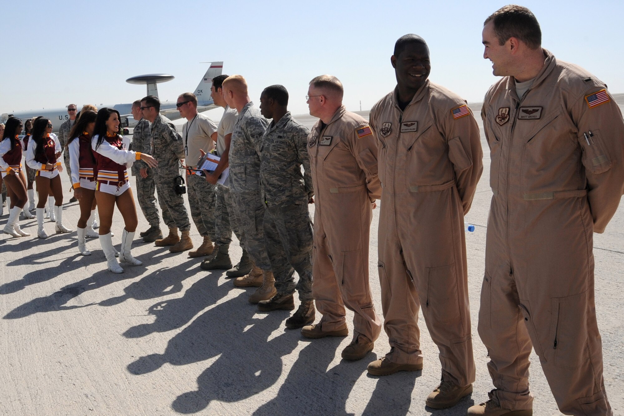 Members of the Washington Redskins cheerleading team greet Airmen of the 308th Air Expenditionary Wing at an unidsclosed location in Southwest Asia on Jan. 30, 2010.  The cheerleaders greeted airmen around the base as well as passed out autographed photos and finished out the day with an hour long variety dance show sponsored by Armed Forces Entertainment. (U.S. Air Force photo/Senior Airman Jenifer H. Calhoun/Released)
