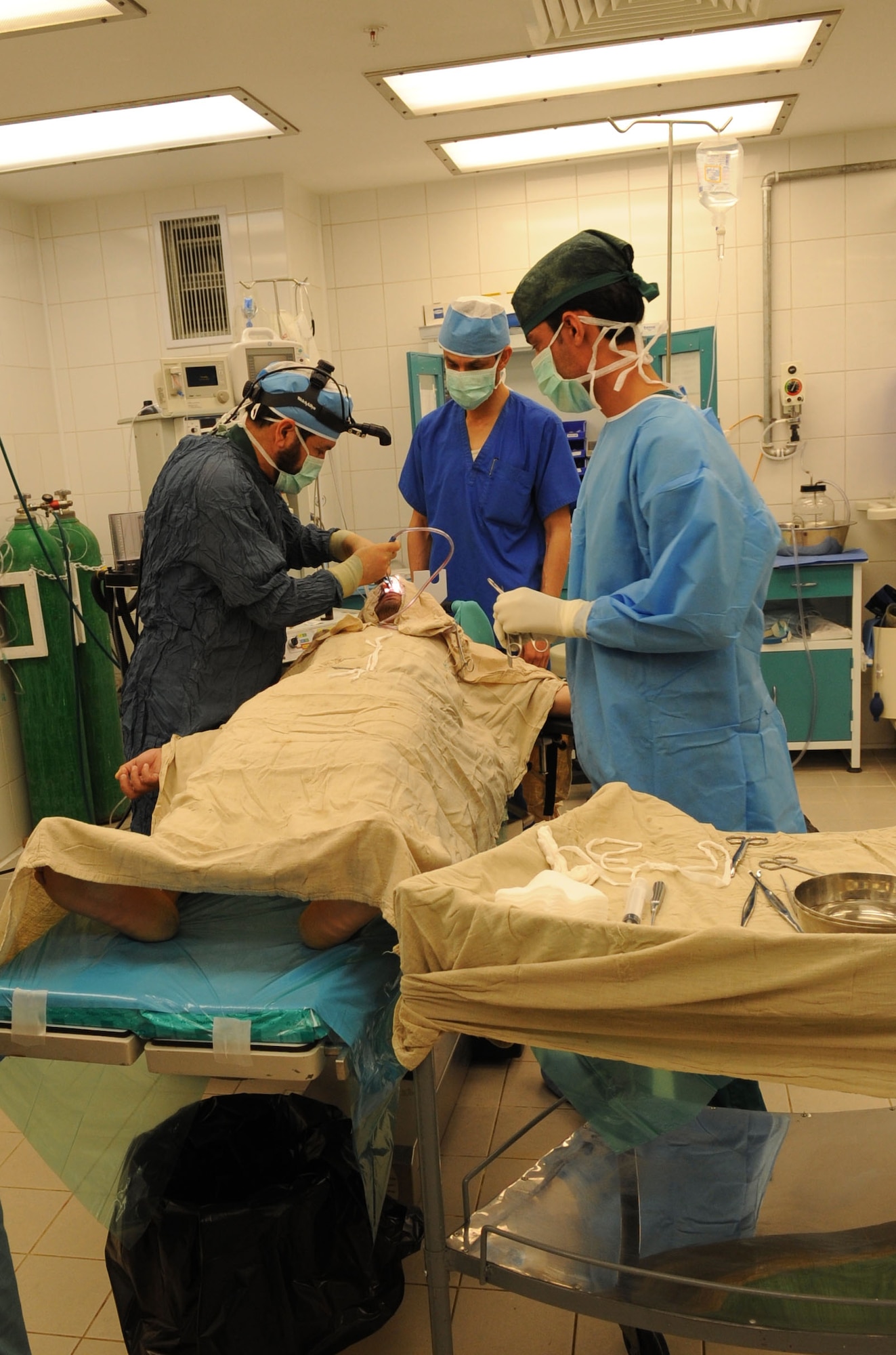 Afghan Dr. Hassan Gul (left) works to fix a patient’s deviated nasal septum in the operating room at the Kandahar Regional Military Hospital. (U.S. Air Force photo/Senior Airman Nancy Hooks/Released)