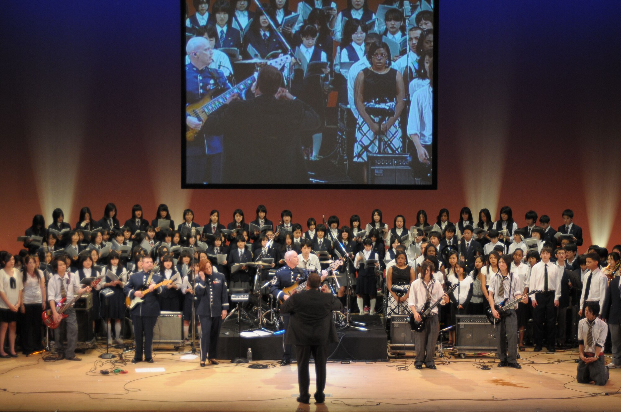 FUSSA, Japan -- The United States Air Force Band of the Pacific-Asia "Final Approach," Fussa's Daiichi, Daini and Daisan Junior High School choirs, the Tokyo Metropolitan Fussa High School rock band and the Yokota High School choir join for a performance Jan. 31, during the 2nd Annual U.S.-Japan joint concert. The concert, hosted by the North Kanto Defense Bureau, was a way to strengthen the Japanese and American relationship. (U.S. Air Force photo/Airman 1st Class Sean Martin)