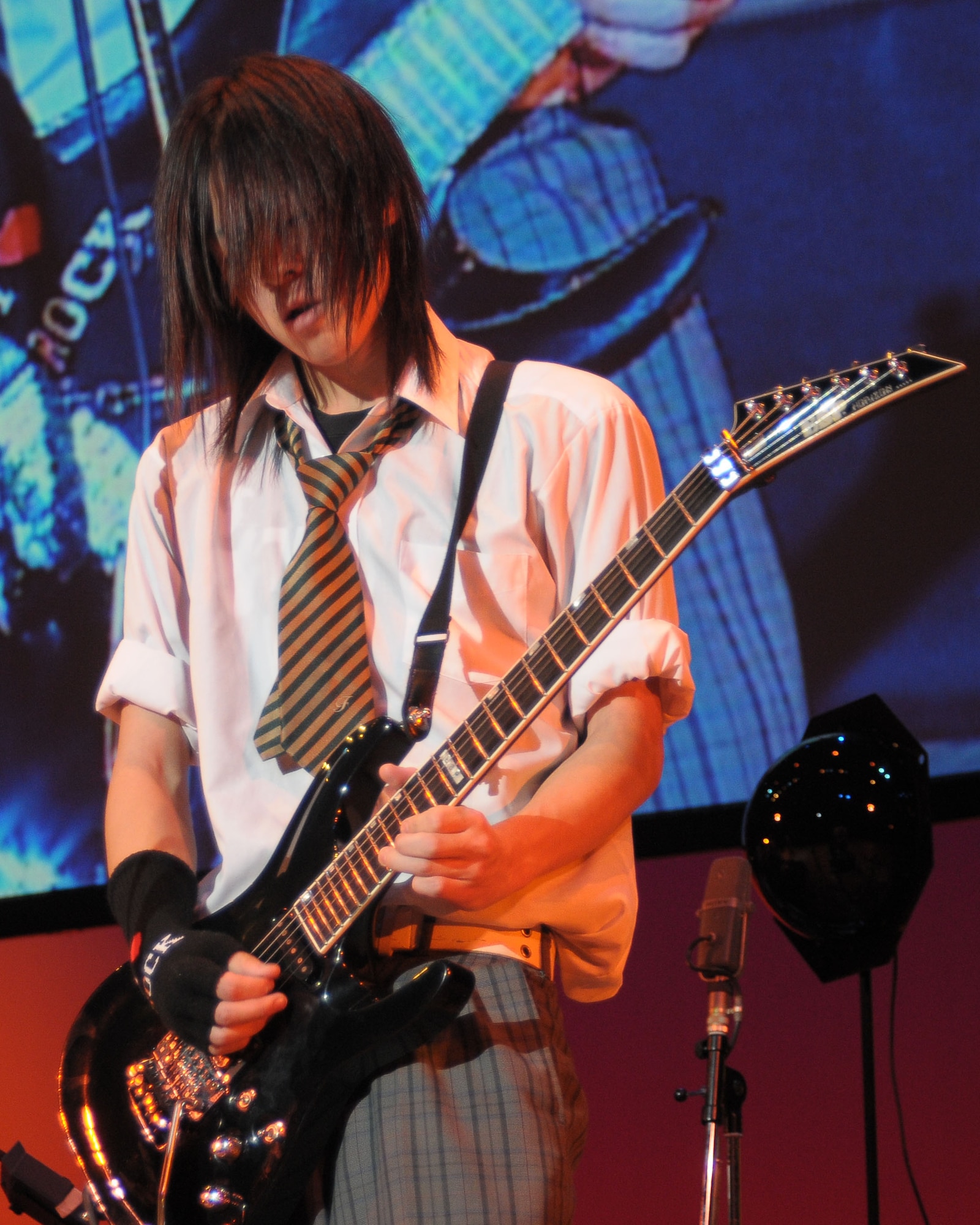 FUSSA, Japan -- A member of the Tokyo Metropolitan Fussa High School rock band performs Jan. 31 for more than 200 people during the U.S.-Japan joint concert. The concert, hosted by the North Kanto Defense Bureau, was a way to strengthen the Japanese and American relationship. (U.S. Air Force photo/Airman 1st Class Sean Martin) 