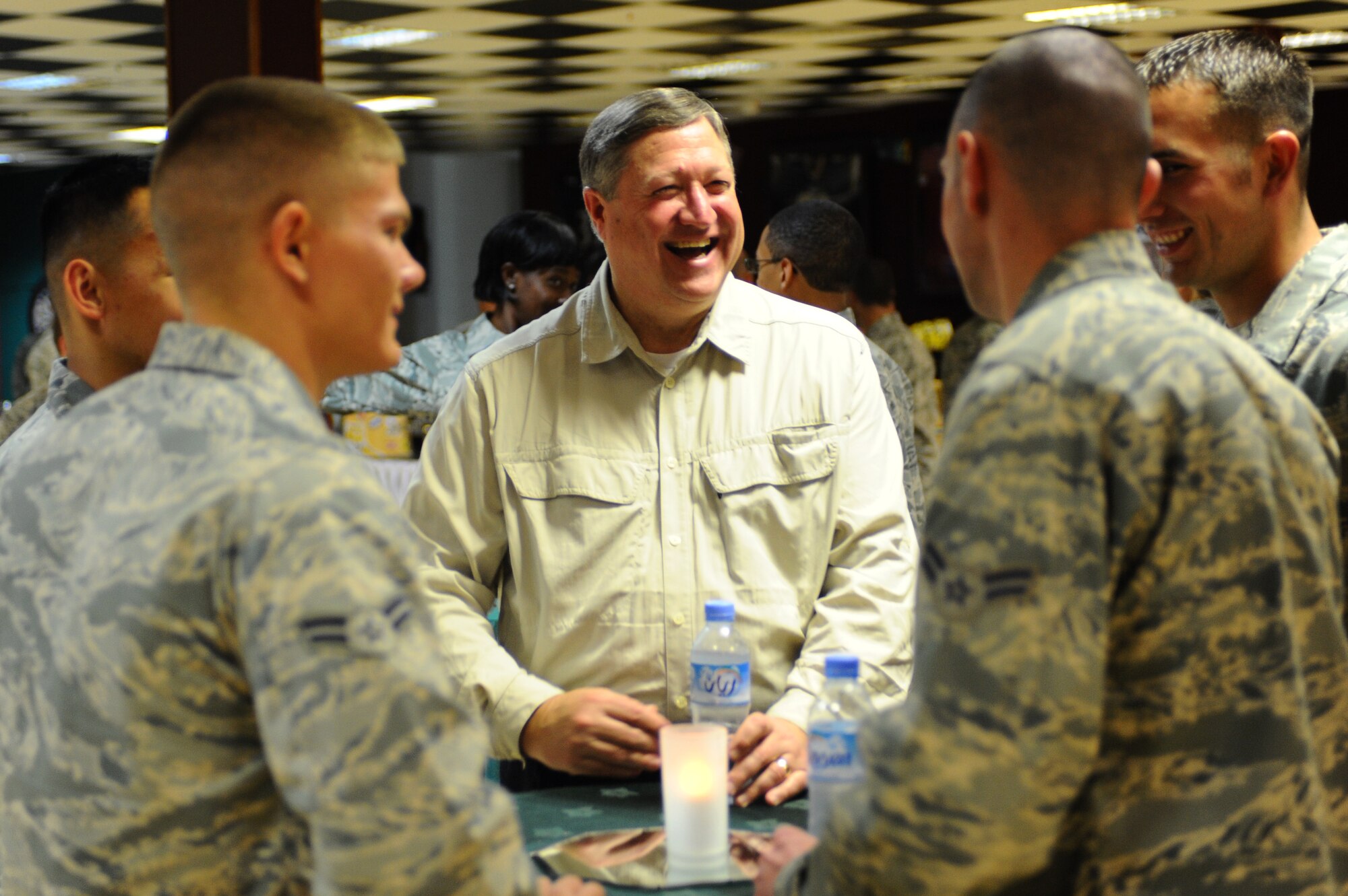 Secretary of the Air Force Michael Donley socializes with 379th Air Expeditionary Wing Airmen during his visit to a non-disclosed Southwest Asia location Jan. 29, 2010. (U.S. Air Force photo by Senior Airman Kasey Zickmund)