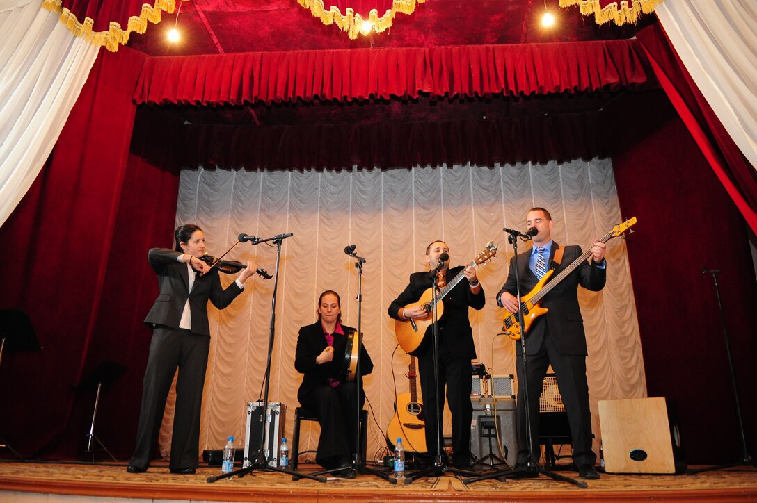 The U.S. Air Forces Central Public Affairs band, "Celtic Aire" performs at a concert hall for local villagers in Tamga Village, Kyrgyzstan Jan. 29, 2010 The band, comprised of four members of the "Singing Sergeants" as well as an accompanying violinist, audio engineer, and officer in charge, is touring Kyrgyzstan for eight days as part of their two-month deployment, and has had the unique opportunity to reach out to local communities. (U.S. Air Force photo/Senior Airman Nichelle Anderson/Released)