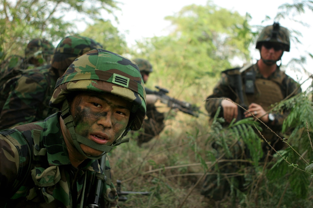 Cpl. Dongkyu Kim, a rifleman with the Republic of Korea Marine Corps, checks for his squad’s alignment with a U.S. Marine infantry squad attached to Battalion Landing Team 2nd Battalion, 7th Marines (BLT 2/7), 31st Marine Expeditionary Unit (MEU), Feb. 3. The MEU is currently participating in exercise Cobra Gold 2010 (CG’ 10). The exercise is the latest in a continuing series of exercises design to promote regional peace and security. (Official Marine Corps photo by Staff Sgt. Leo A. Salinas)
