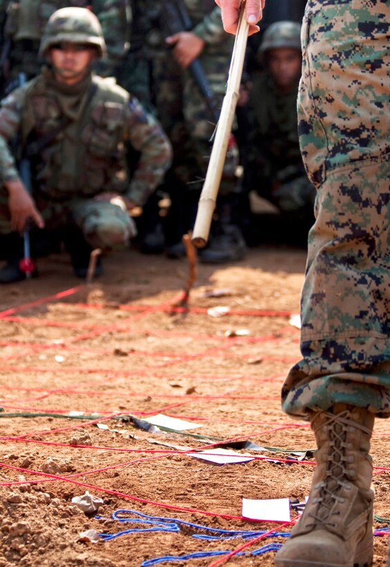A U.S. Marine assigned to the Combat Logistics Battalion 4 reviews the day’s convoy training with Royal Thai Soldiers assigned to the 9th Infantry Division Feb. 4. The training is part of Exercise Cobra Gold 2010. This year marks the 29th anniversary for the exercise, which consists of a Global Peacekeeping Operations Initiative Exercise, Command Post Exercise, Humanitarian Civic Assistance projects and field training exercises.