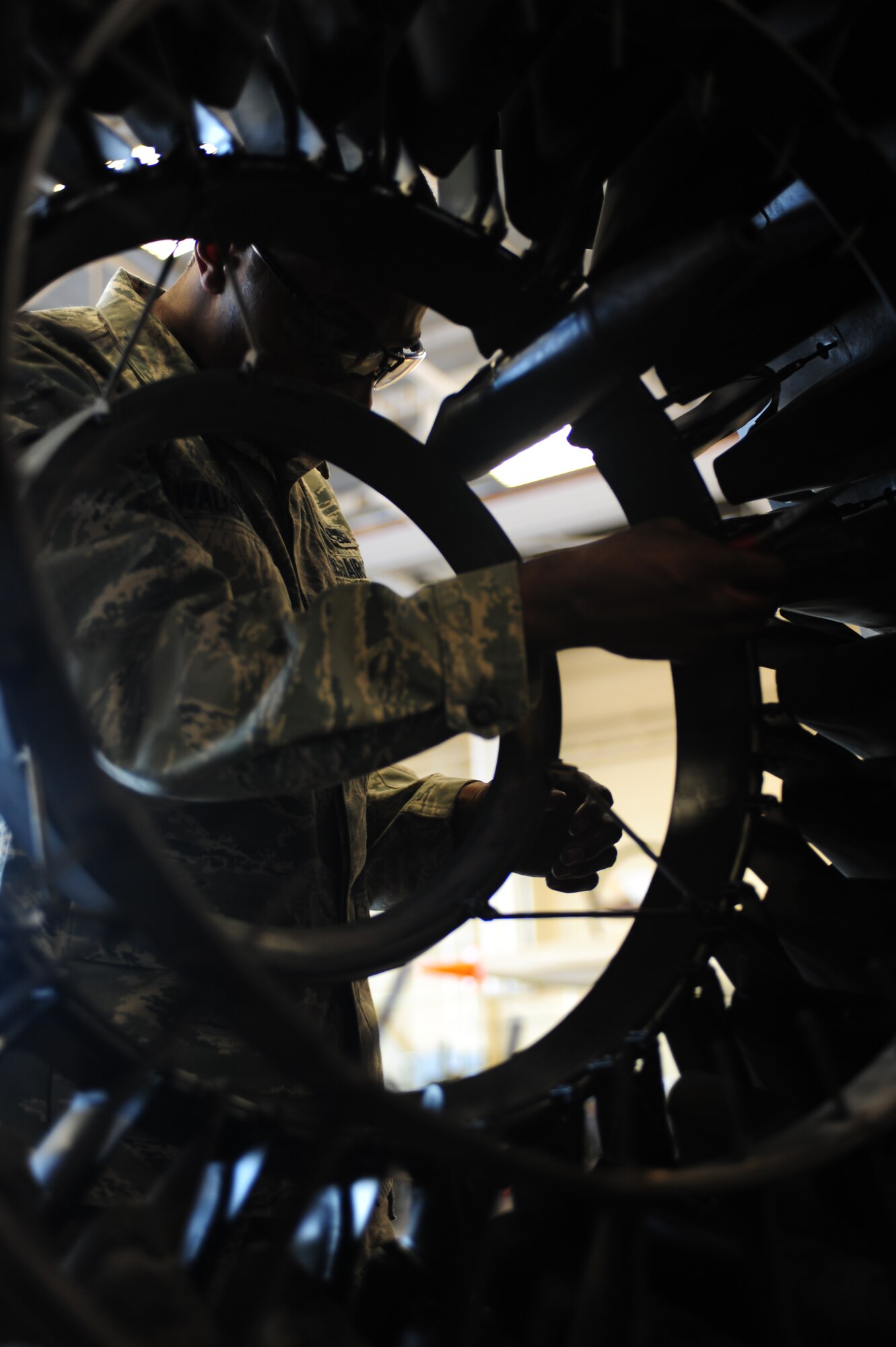 ELLSWORTH AIR FORCE BASE, S.D. --  Airmen 1st Class Kymric Walker, 28th Maintenance Squadron aerospace propulsion maintenance apprentice, removes S-pins inside the augmenter flame holder from a B-1B Lancer engine, Feb 3.  While working inside the augmenter flame holder, Airman Walker ensures his eyes are protected through the use of proper protective equipment. (U.S Air Force photo/Airman 1st Class Anthony Sanchelli)