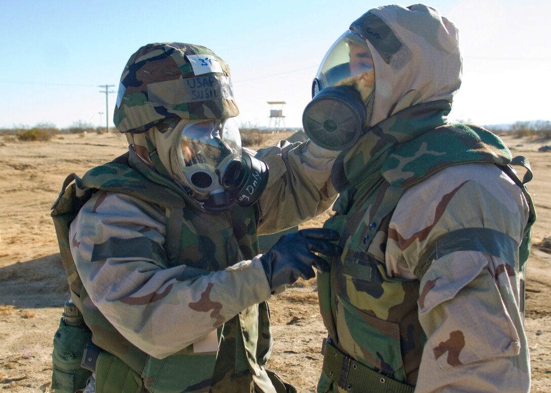 Lt. Col. Susie Lewis, 95th Force Support Squadron commander, performs buddy check on another Airman during Phase II of the base's Operational Readiness Exercise Jan. 28. The purpose of the exercise was to prepare base personnel for any potential real-world crisis or deployment. (Air Force Photo/Mike Cassidy)
