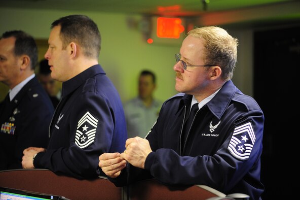 FAIRCHILD AIR FORCE BASE, Wash. - Chief Master Sgt. Charles Haley, Washington Air National Guard Command Chief, right, focuses as a briefer at the newly integrated MOC discusses Total Force goals. The collocated MOC is a new initiative falling under the TFI umbrella. (U.S. Air Force photo / Senior Airman Joshua Chapman)