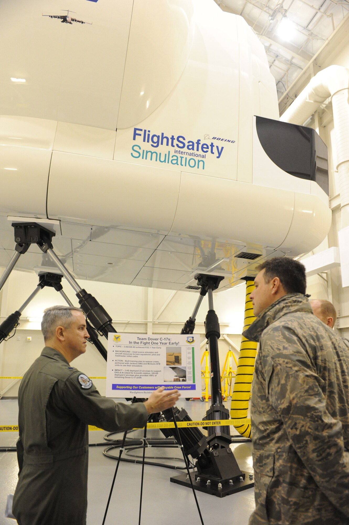 (Left) Lt. Col. Kevin Higginbotham, 326th Airlift Squadron, briefs Col. John Bird, Installation Excellence Selection Board member, Feb. 2, about the methods used to get the 3rd AS and 326th AS to full operational capability. (U.S. Air Force photo/Roland Balik)