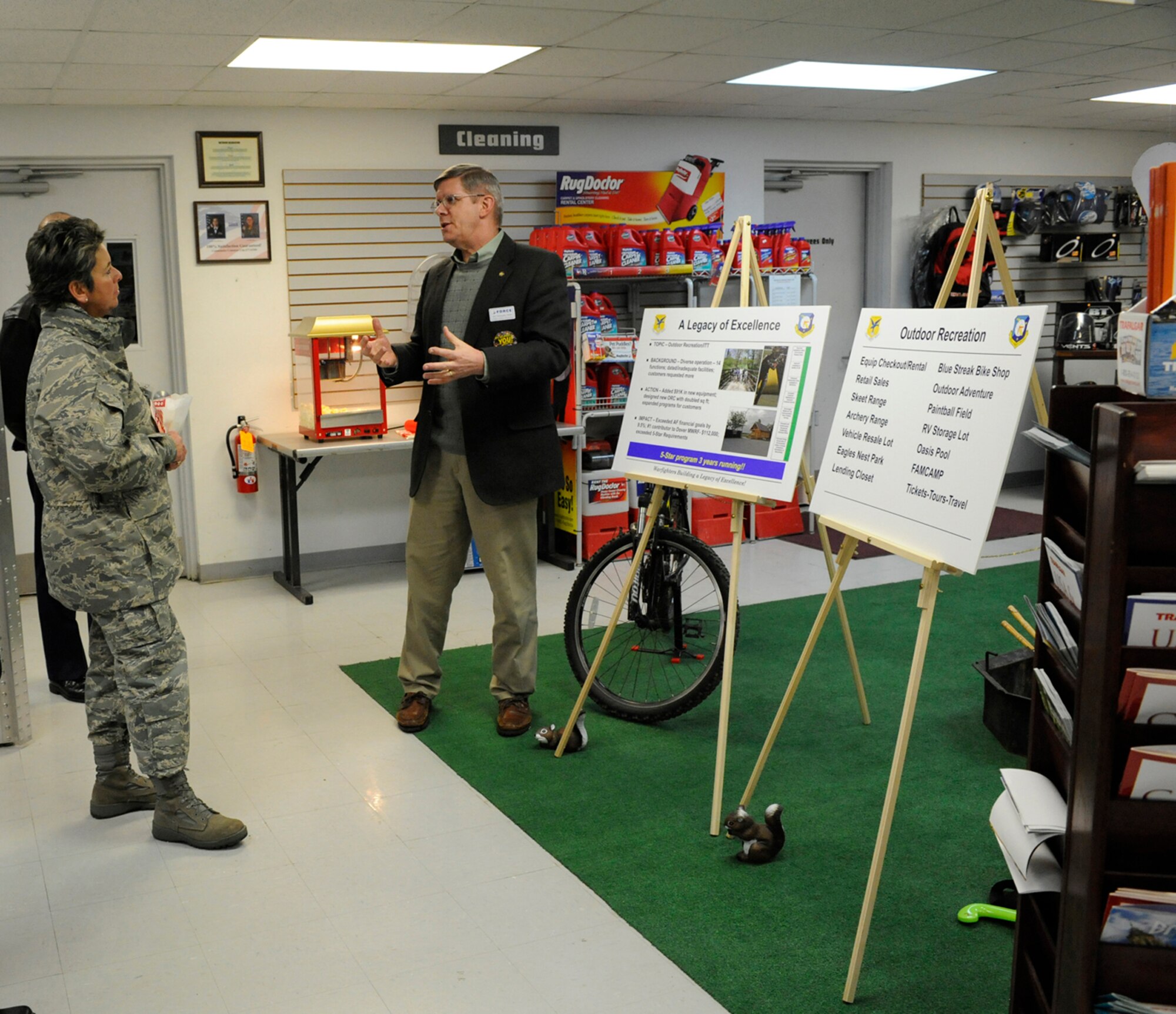 (Right) Chris Smith, 436th Force Support Squadron, briefs Maj. Gen. Anita Gallentine, Installation Excellence Selection Board chief, Feb. 1. Mr. Smith spoke about the five-star level of the Outdoor Recreation program and that it gained this excellence by expanding with $91,000 worth of equipment and beating its planned financial goals.  (U.S. Air Force photo/Jason Minto)