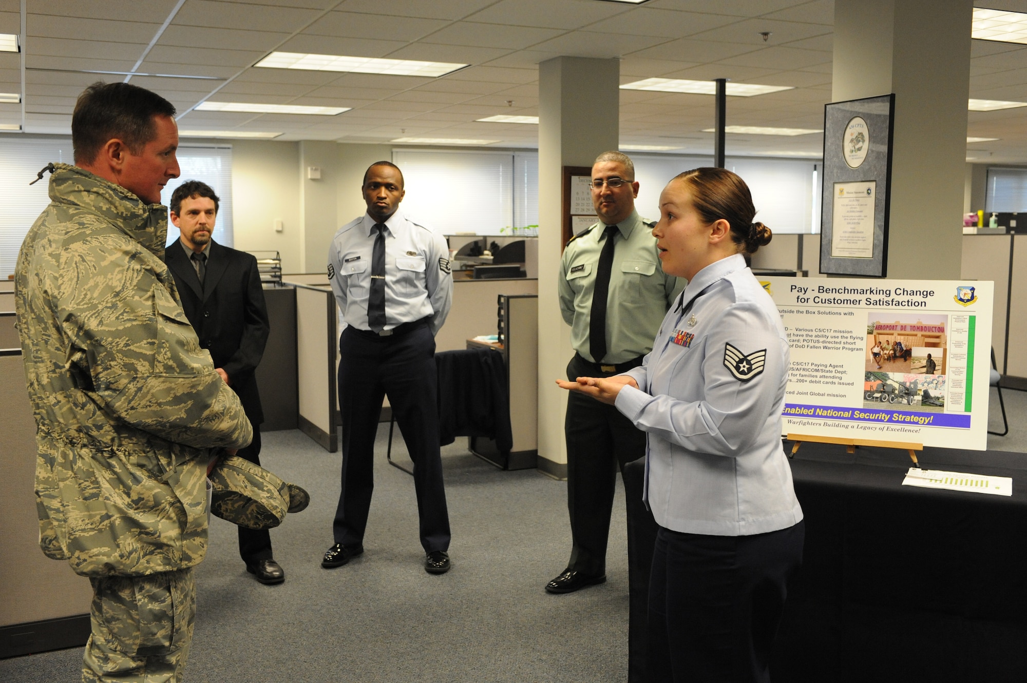 (Right) Staff Sgt. Pamela Coats, 436th Comptroller Squadron, briefs Co. Stephen Clark, Installation Excellence Selection Board member, Feb. 1. Sergeant Coats? briefing covered how the 436th CPTS assisted families under the Department of Defense Fallen Warriors support program. (U.S. Air Force photo/Roland Balik)