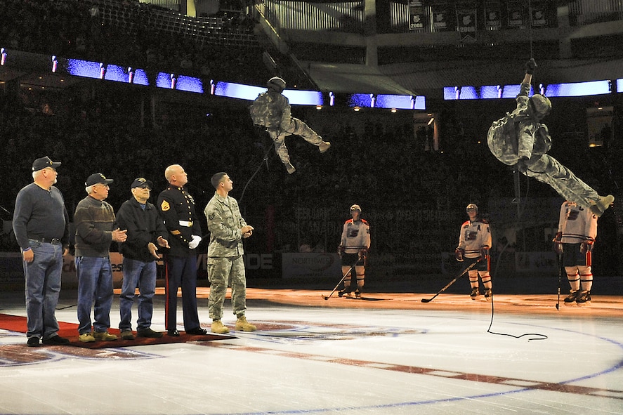 FAIRCHILD AIR FORCE BASE, Wash. - U.S. military veterans and current servicemembers watch as two Soldiers descend from the ceiling of the Spokane Arena during an annual Military Appreciation Night here Jan. 30. The members shown
represent veterans of the current wars in Iraq and Afghanistan, the Gulf War, the Vietnam War, the Korean War and World War II. (U.S. Air Force photo / Senior Airman Joshua Chapman)