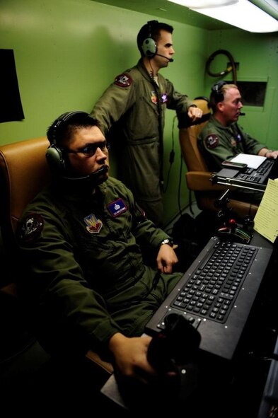 AGUADILLA, PUERTO RICO – From left to right, Tech. Sgt. Ron Zechman, sensor operator, Capt. Aaron Zastrow, pilot, and Maj. Jeff Bright, pilot operate an RQ-1 Predator here  in support of Operation Unified Response Jan. 27. Major Bright, Captain Zastrow, and Sergeant Zechman are assigned to the 11th Reconnaissance Squadron. (Courtesy photo) 