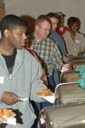 MINOT AIR FORCE BASE, N.D. -- Minot Airmen stand in line for food at the 45th Annual Sportsmen Feed held at the Jimmy Doolittle Center here Jan. 31. The feed is an annual event designed to build fellowship between the base and local community. (U.S. Air Force photo by Airman 1st class Aaron-Forrest Wainwright)