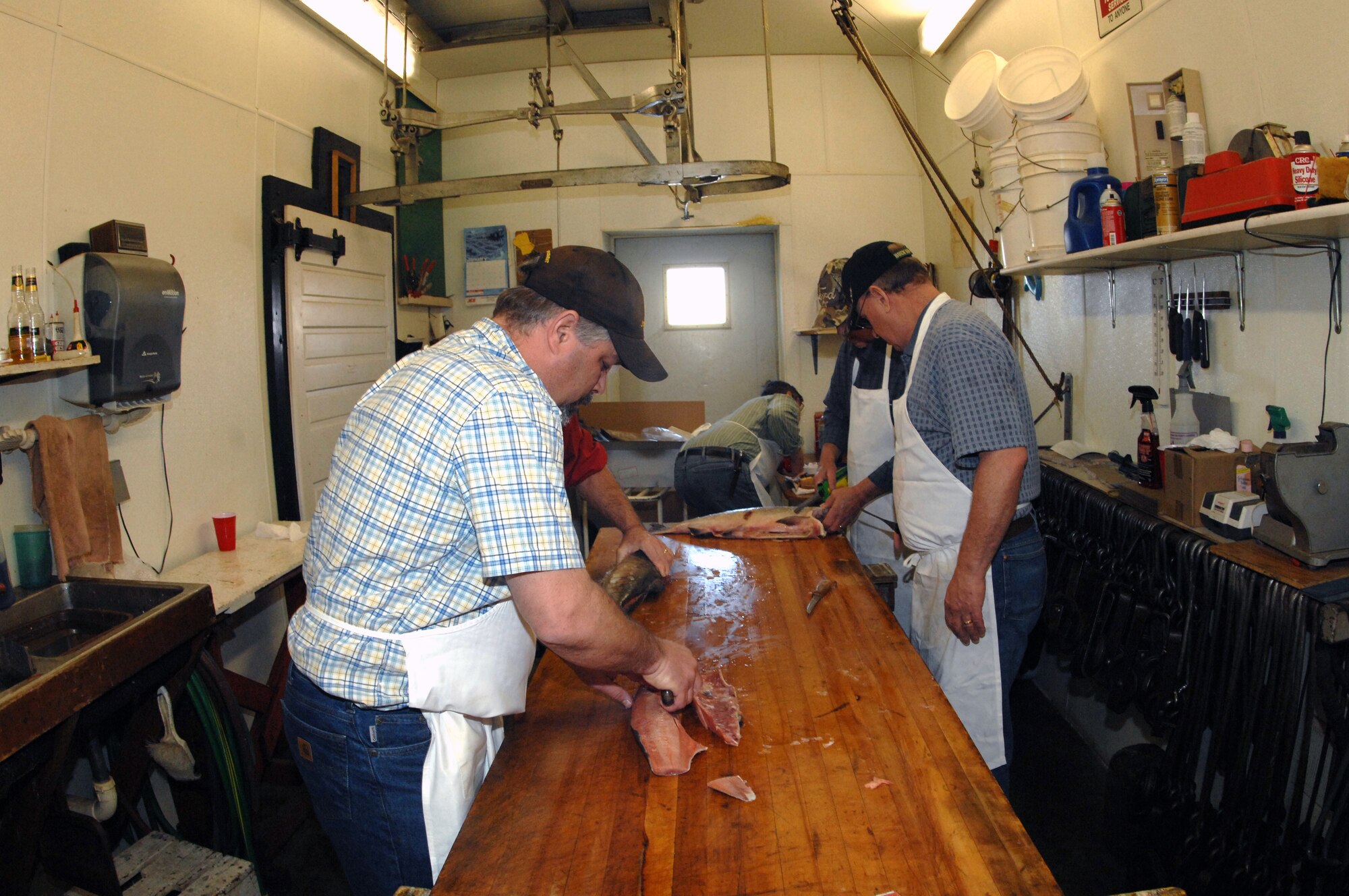 MINOT, N.D.  -- Sportsmens Feed members prepare food for the 45th Annual Sportsmen Feed here Jan. 29,  for the upcoming 45th Annual Sportsmen Feed, which is an annual event designed to build fellowship between the base and local community, was held at the Jimmy Doolittle Center here Jan. 31. (U.S. Air Force photo by Airman 1st Class Aaron-Forrest Wainwright)
