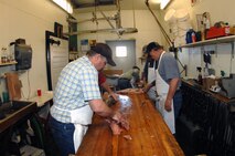 MINOT, N.D.  -- Sportsmens Feed members prepare food for the 45th Annual Sportsmen Feed here Jan. 29,  for the upcoming 45th Annual Sportsmen Feed, which is an annual event designed to build fellowship between the base and local community, was held at the Jimmy Doolittle Center here Jan. 31. (U.S. Air Force photo by Airman 1st Class Aaron-Forrest Wainwright)
