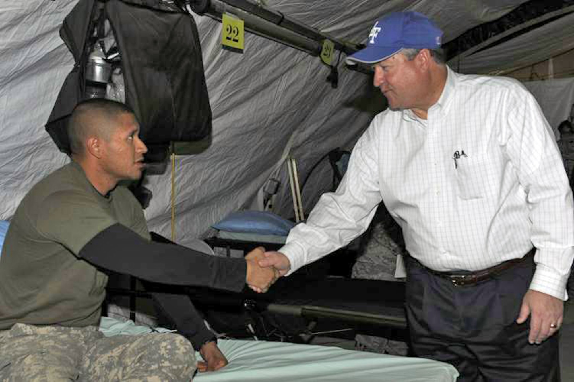Secretary of the Air Force Michael Donley visits with Army Spc. Eric Morales who's a patient at the Craig Joint Theater Hospital Feb. 2, 2010, at Bagram Airfield, Afghanistan. Secretary Donley was in Afghanistan to monitor the training efforts of the Afghanistan National Army Air Corps and to meet with Airmen. Specialist Morales is assigned to the 1st Battalion, 12th Infantry. (U.S. Air Force photo/Tech. Sgt. Jeromy K. Cross)