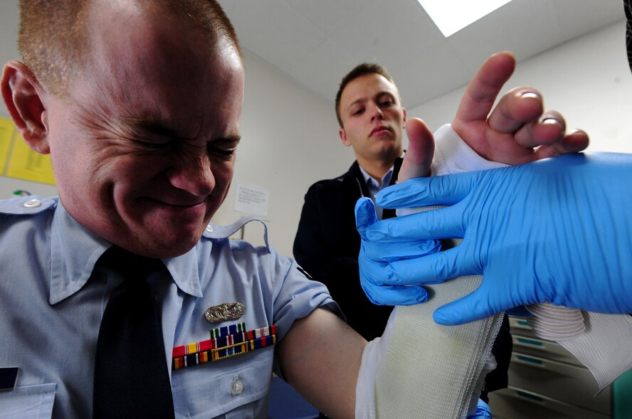 ELLSWORTH AIR FORCE BASE, S.D. -- Airman Albert Thorn, 28th Medical Operations Squadron aerospace medical technician, assists in applying a temporary cast to the arm of Airman 1st Class Christopher Miller, 28th Security Forces Squadron, Feb. 1, 2010. The 28 MDOS treats a wide variety of medical issues ranging from sickness, injuries, and dental. (U.S. Air Force photo/Airman 1st Class Joshua J. Seybert)