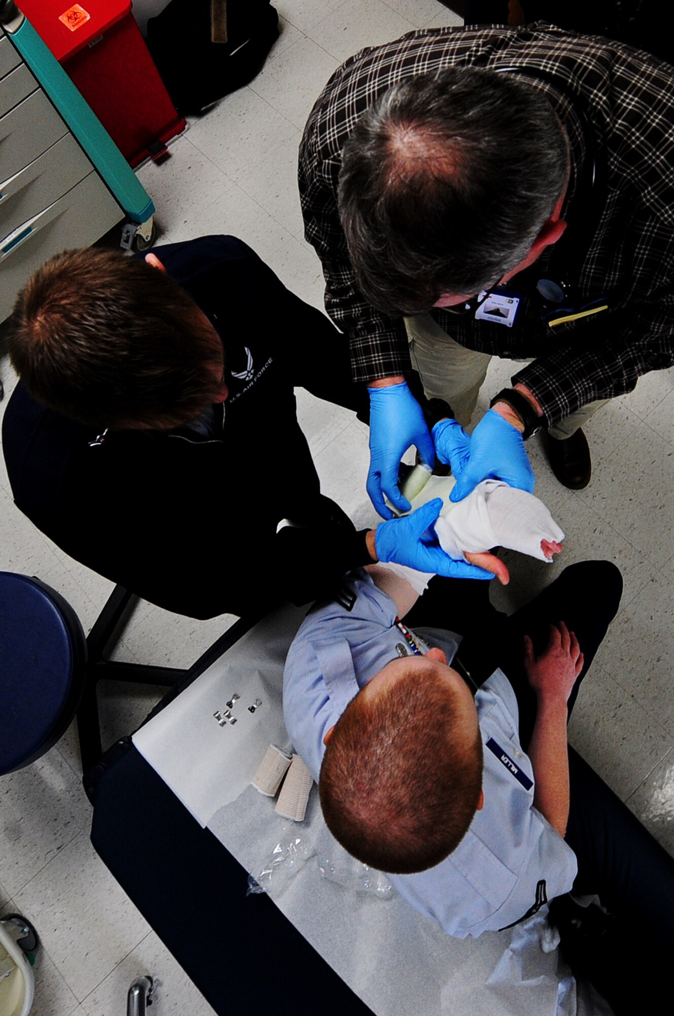 ELLSWORTH AIR FORCE BASE, S.D. -- Airman Albert Thorn, 28th Medical Operations Squadron aerospace medical technician, assists Kevin Wilson, 28 MDOS nurse, apply a temporary cast to the arm of Airman 1st Class Christopher Miller, 28th Security Forces Squadron, Feb. 1, 2010. The 28 MDOS treats a wide variety of medical issues ranging from sickness, injuries, and dental. (U.S. Air Force photo/Airman 1st Class Joshua J. Seybert)