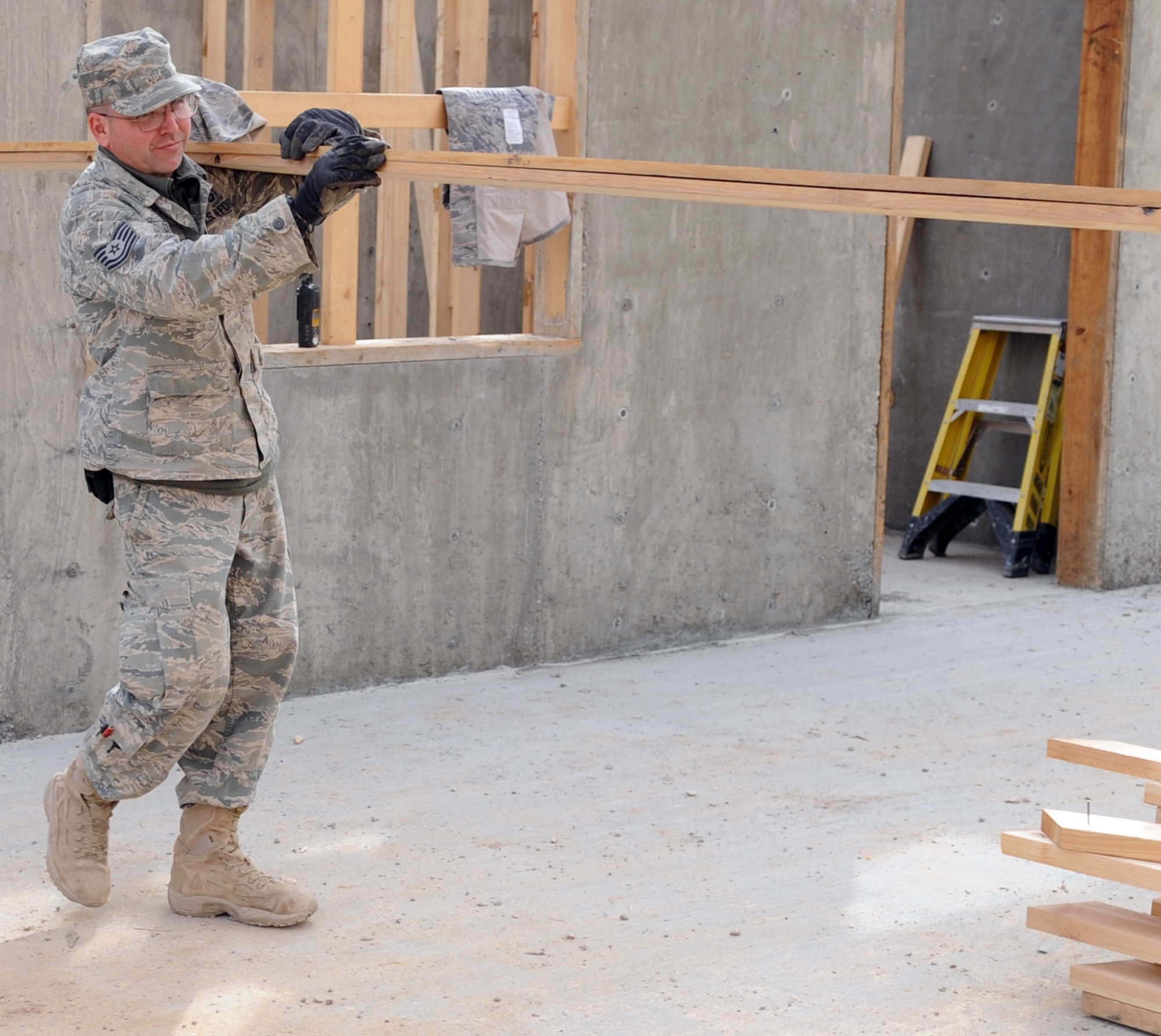 Tech. Sgt. Mark Duran builds support beams Jan. 28, 2010 at Kirkuk Air Base, Iraq. Sergeant Duran is now six years cancer free. He is a 506th Expeditionary Civil Engineer Squadron structures technician deployed from 301st Civil Engineer Squadron Joint Reserve Field Carswell Fort Worth, Texas. (U.S. Air Force photo/Staff Sgt. Tabitha Kuykendall)