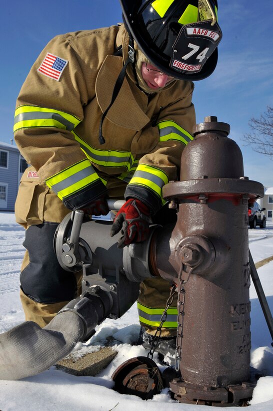 Senior Airman Jason Holmes, 316th Civil Engineer Squadron firefighter, connects a gate valve to a fire hydrant during a hazarous material exercise Feb. 1, 2010, at Joint Base Andrews, Md. The valves helps the firefighter slowly release water to the fire engine to control pressure changes and make sure there is no air in the hose that could damage the engine. (U.S. Air Force photo by Airman 1st Class Perry Aston)