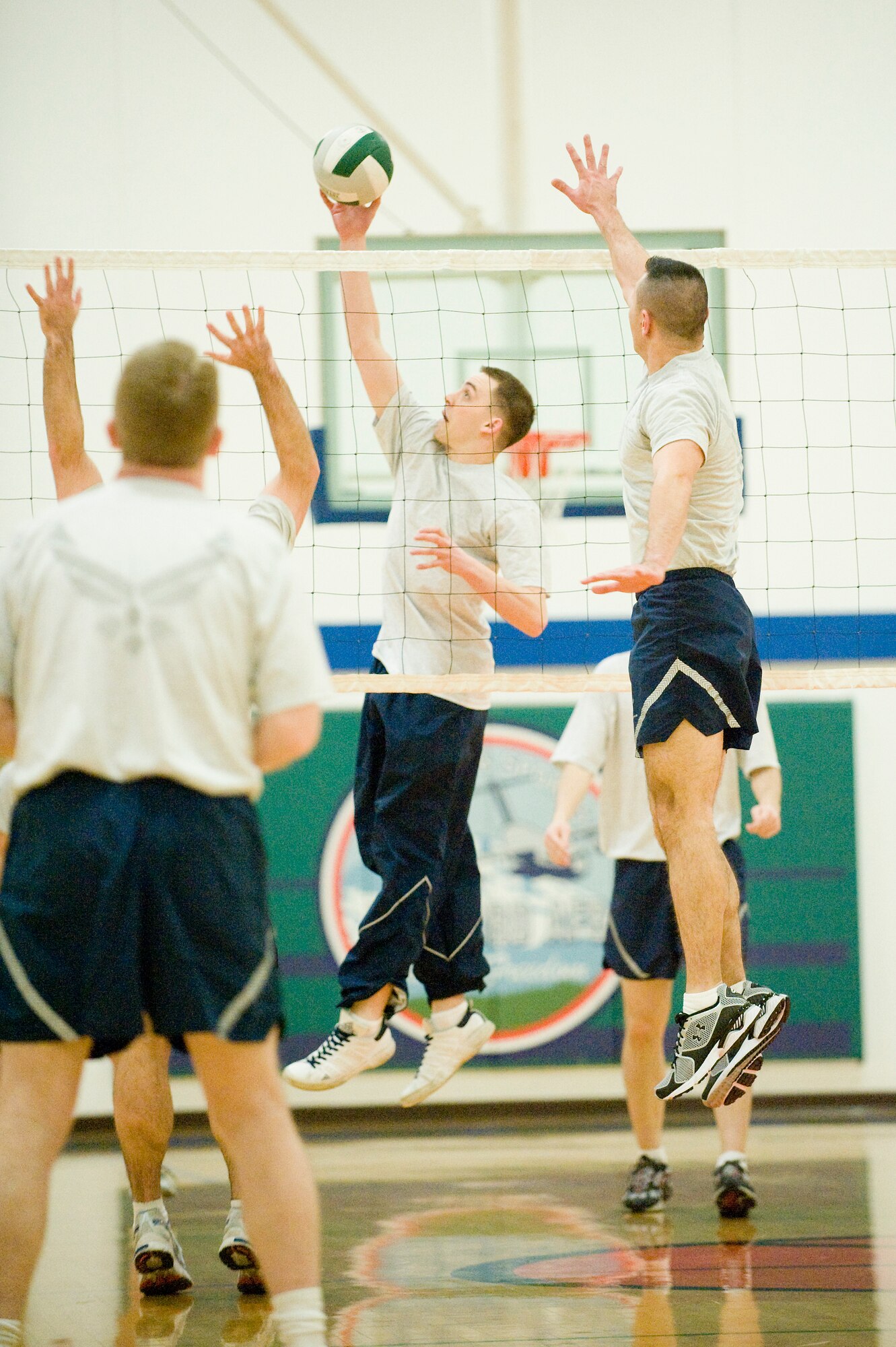 Joint Base Lewis-McChord Airmen play a game of volleyball as part of a physical fitness training session at the McChord Fitness Center. Revisions to the Air Force fitness program take effect July 1. Biannual testing under the current standards begins Jan. 1. (U.S. Air Force photo/Abner Guzman)