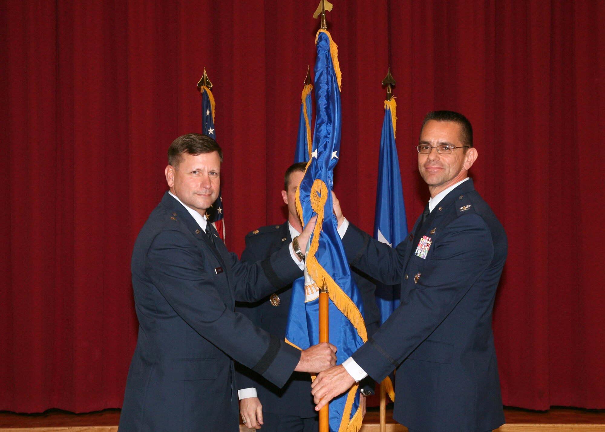Brig. Gen. Leonard A. Patrick (left), 502nd Air Base Wing commander, presents the 802nd Mission Support Group guidon to Col. Patrick Fogarty, the group's commander, during an activation ceremony Feb. 2 at the Gateway Club. (U.S. Air Force photo/Robbin Cresswell) 
