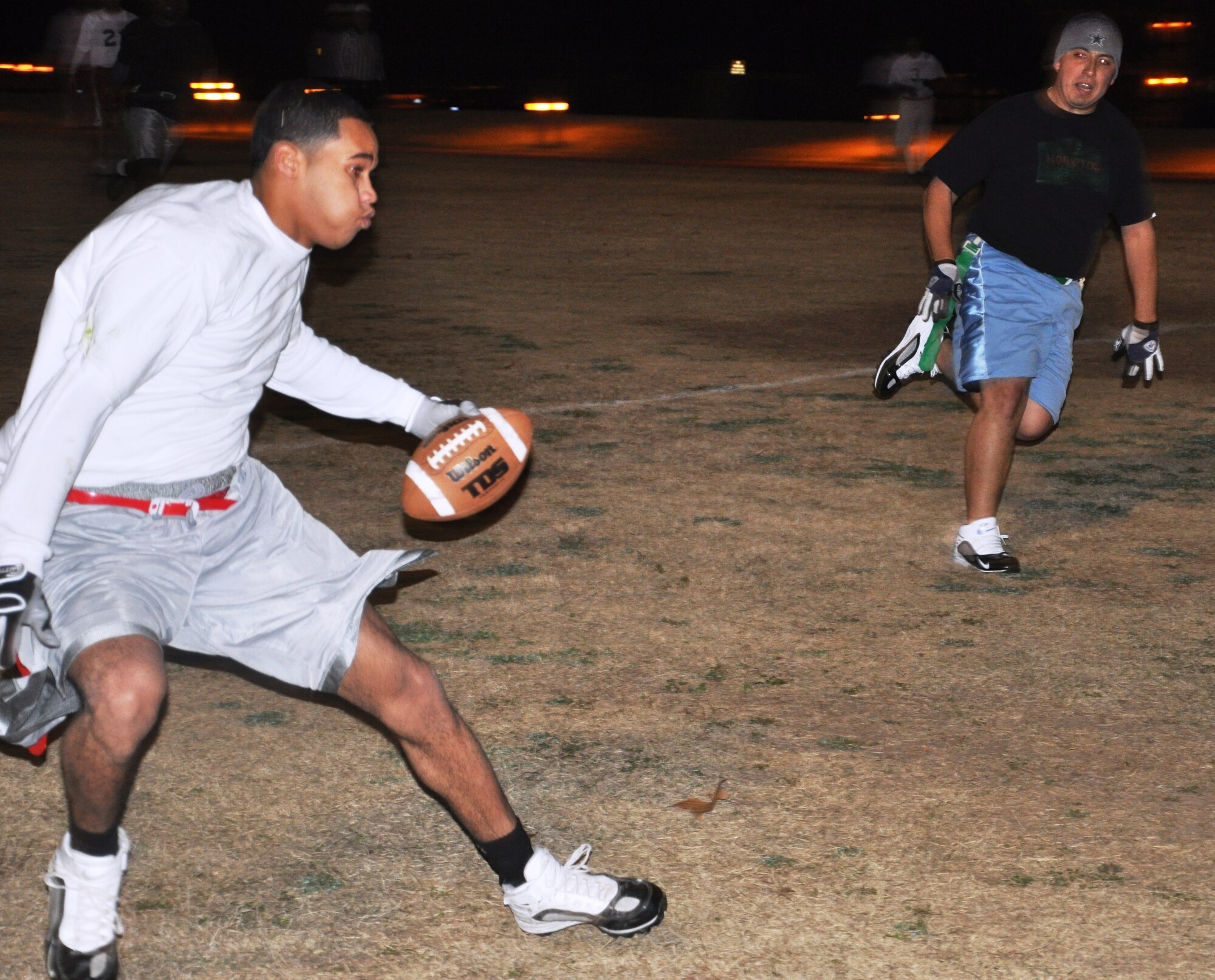 LAUGHLIN AIR FORCE BASE, Texas – Senior Airman Luke Smith, 47th Operations Support Squadron, attempts to elude defenders from the 47th Force Support Squadron team during the Laughlin flag football championship game here Feb. 1. The team from the 47th OSS defeated 47th FSS 21 to 12 to claim the championship. (U.S. Air Force photo by Airman 1st Class Blake Mize)