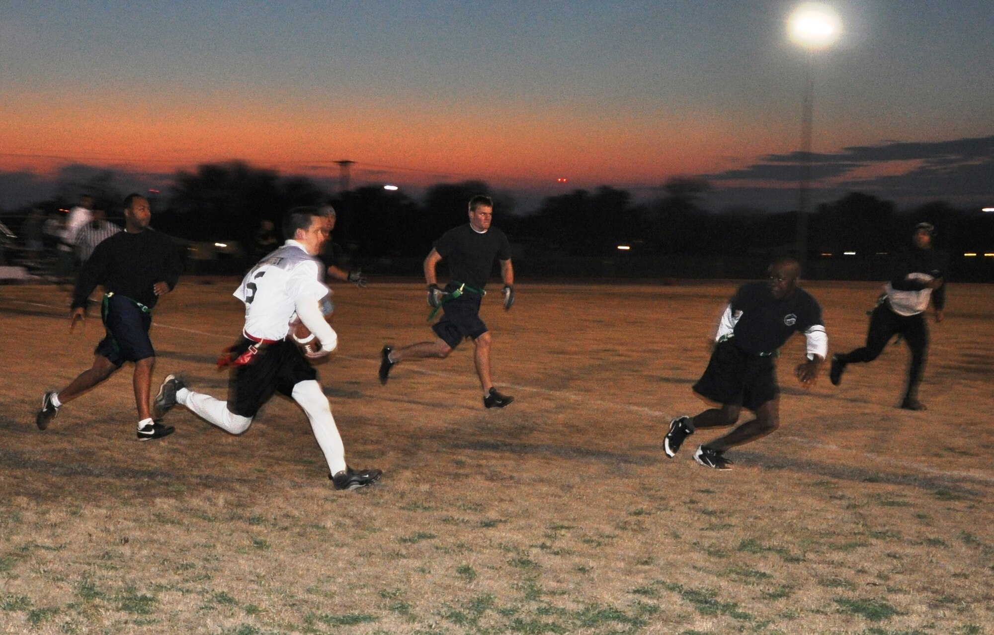 LAUGHLIN AIR FORCE BASE, Texas – Airman 1st Class Richard Weatherby, 47th Operations Support Squadron, attempts to elude defenders from the 47th Force Support Squadron team during the Laughlin flag football championship game here Feb. 1. The team from the 47th OSS defeated 47th FSS 21 to 12 to claim the championship. (U.S. Air Force photo by Airman 1st Class Blake Mize)