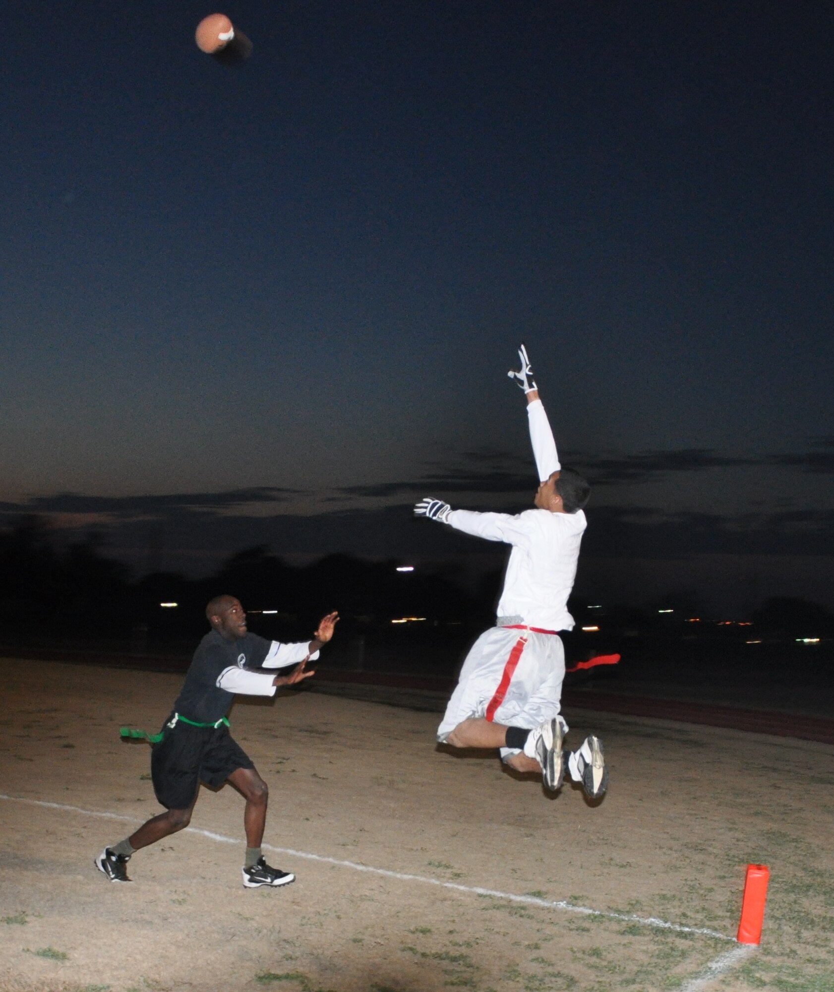 LAUGHLIN AIR FORCE BASE, Texas – Senior Airman Luke Smith, 47th Operations Support Squadron, leaps for a catch as Airman 1st Class Remario Barley, 47th Security Forces Squadron, defends him during the Laughlin flag football championship game here Feb. 1. The team from 47th OSS defeated the 47th Force Support Squadron 21 to 12 to claim the championship. (U.S. Air Force photo by Airman 1st Class Blake Mize)