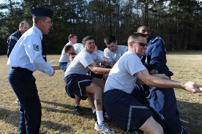 U.S. Air Force Tech. Sgt. Brandon Hutchins cheers on Airman Leadership School students during a fitness challenge at the base picnic grounds here Feb.1, 2010. More than 40 students and instructors from the Airman Leadership School and First Term Airmen Center teamed up to hold the games as a fun fitness challenge. Sergeant Hutchins is an ALS instructor. (U.S. Air Force photo/James M. Bowman)
