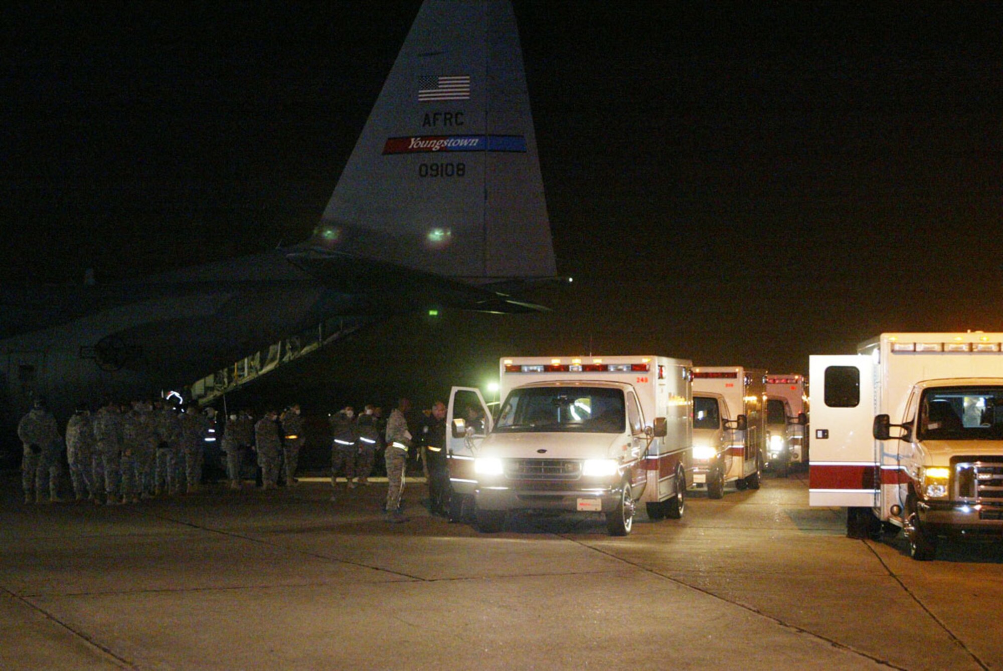 Metro Atlanta ambulances dispatched to Dobbins Air Reserve Base to transport injured Haitian earthquake victims line up outside a C-130 aircraft on the flight line Feb. 2. Half a dozen injured Haitians were flown into Dobbins ARB on a C-130 aircraft late Feb. 2 and transported to local hospitals for urgent care. (U.S. Air Force photo/Don Peek)  

