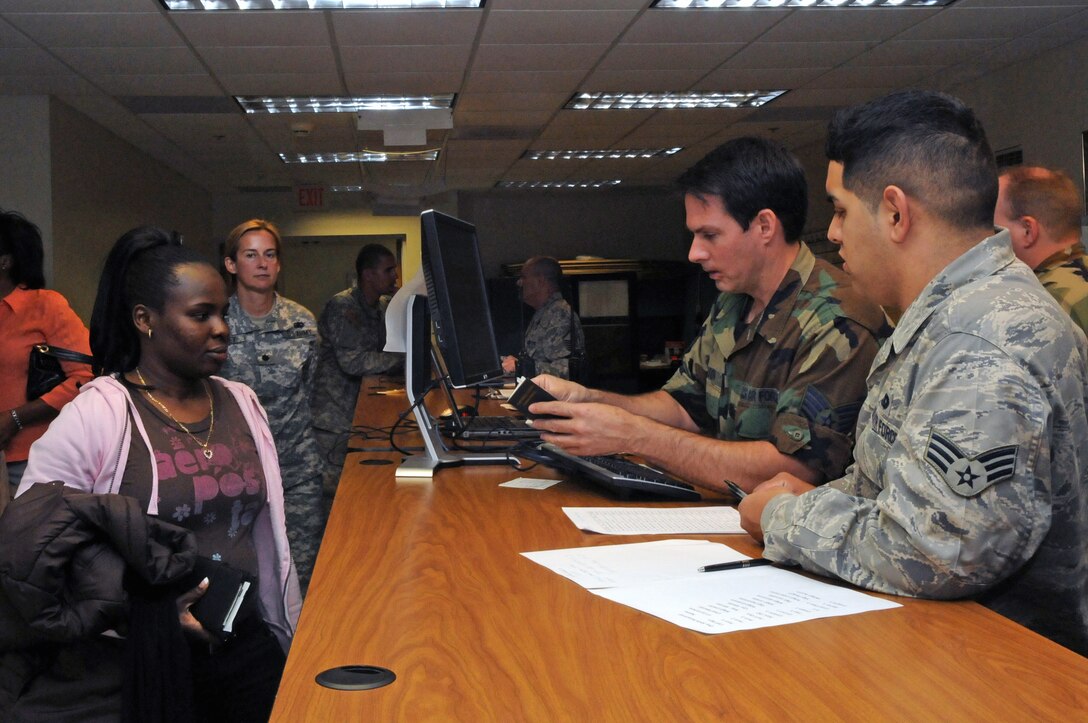 Tech. Sgt. Robert Gibson and Senior Airman Carlos Ramos ready Nadia Jean-Lois of the Haitian coast guard for her flight to Haiti in support of Operation Unified Response Jan. 23, 2010, at Homestead Air Reserve Base, Fla. Sergeant Gibson and Airman Ramos are 70th Aerial Port Squadron passenger terminal representatives. (U.S. Air Force photo/Master Sgt. Sabrina Johnson)