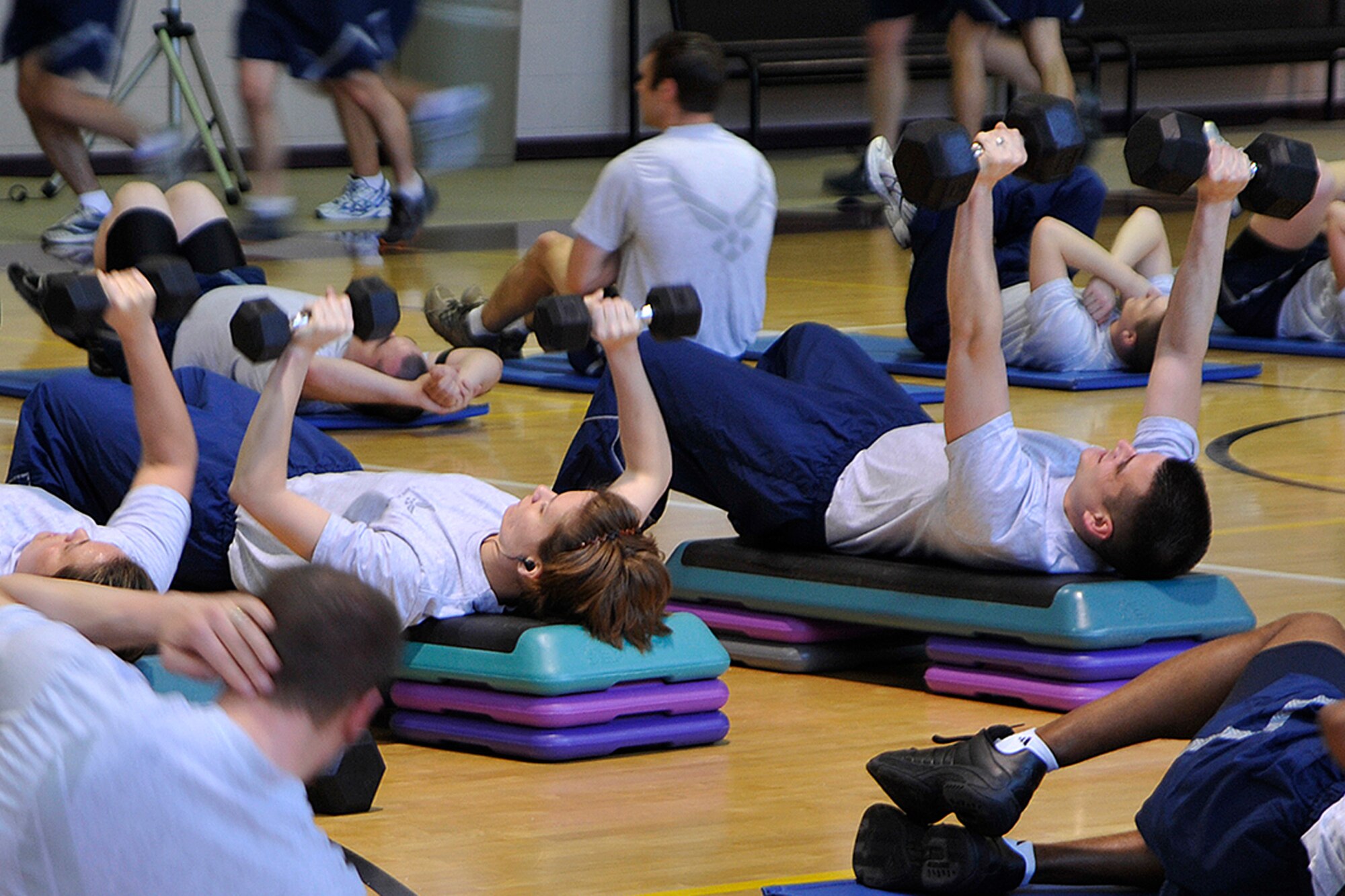 PETERSON AIR FORCE BASE, Colo. -- 21st Space Wing Airmen perform strength training exercises Jan. 28 at the Peterson Fitness and Sports Center during Wing Warrior Day. About 400 Airmen performed exercises including spinning, running, stretching and weight-lifting in two 60-minute sessions. Wing Warfit was also a reminder of the new Air Force fitness culture which emphasizes fitness year-round. (Air Force photo by Rob Bussard)